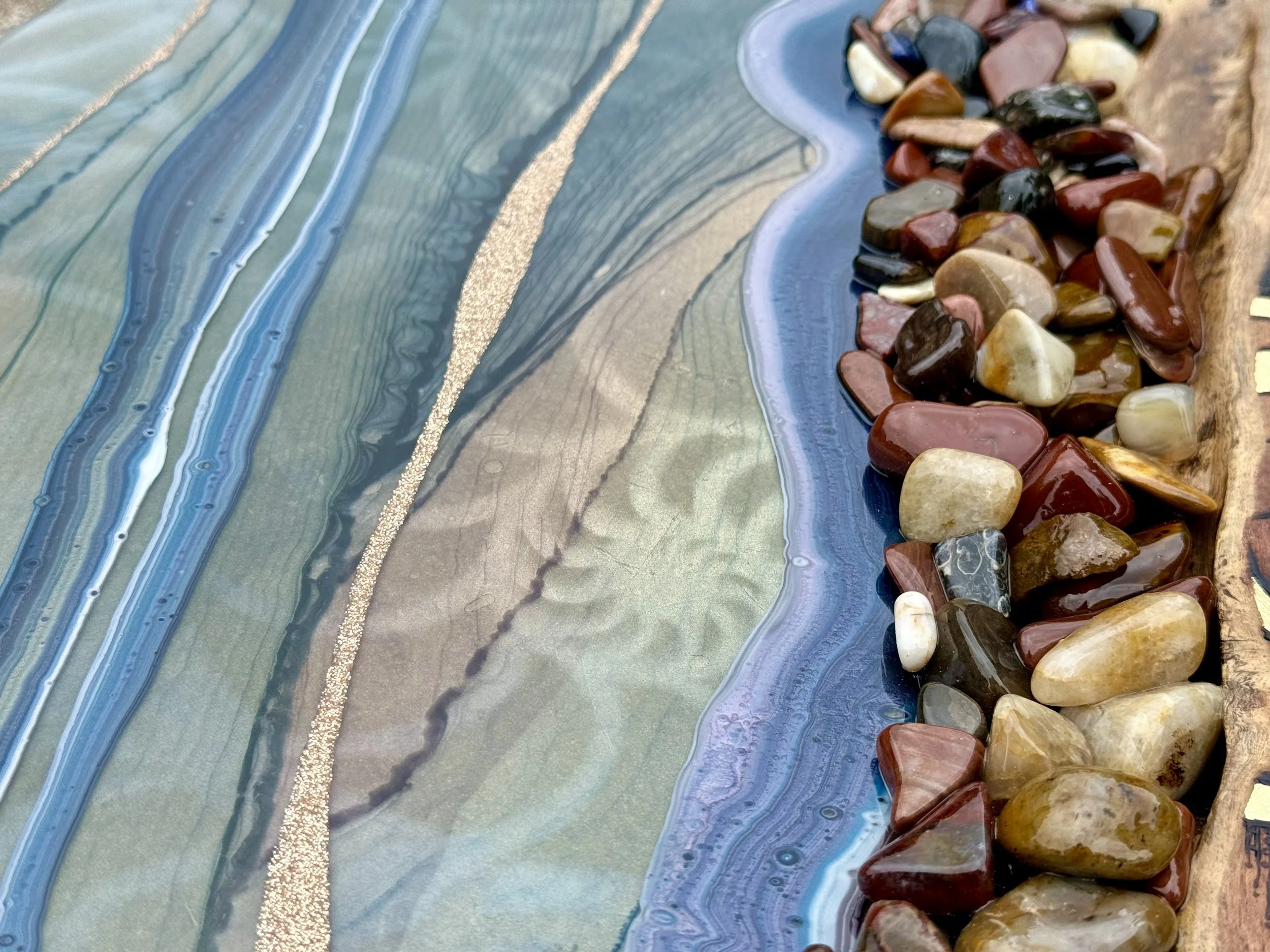 Pyrography wall art with river rocks, metal leaf, and resin by Austin Texas artist