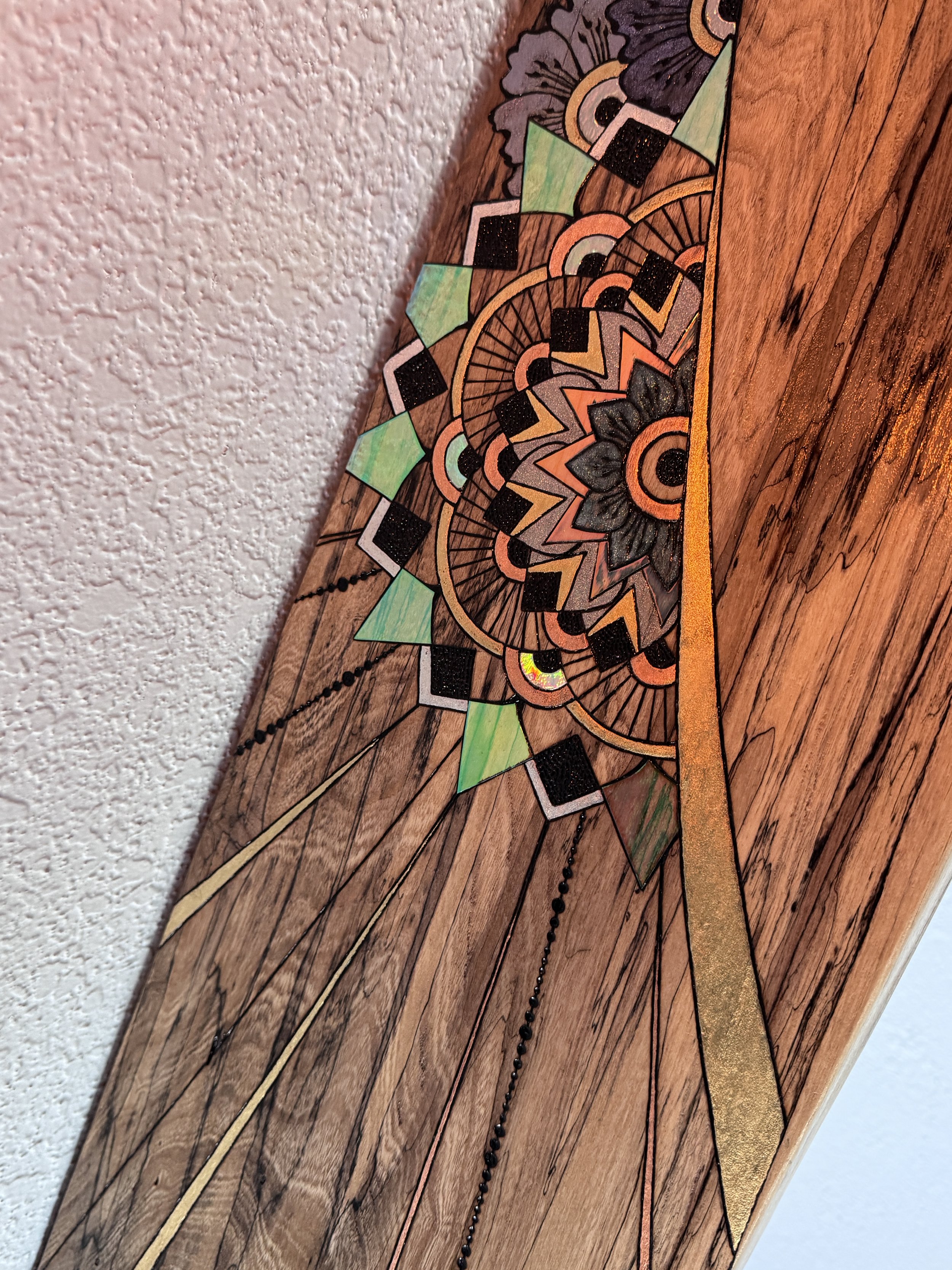 Angled view of Storyteller by Anne Shackelford showing the live edge, sculptural form, and artwork from the side.