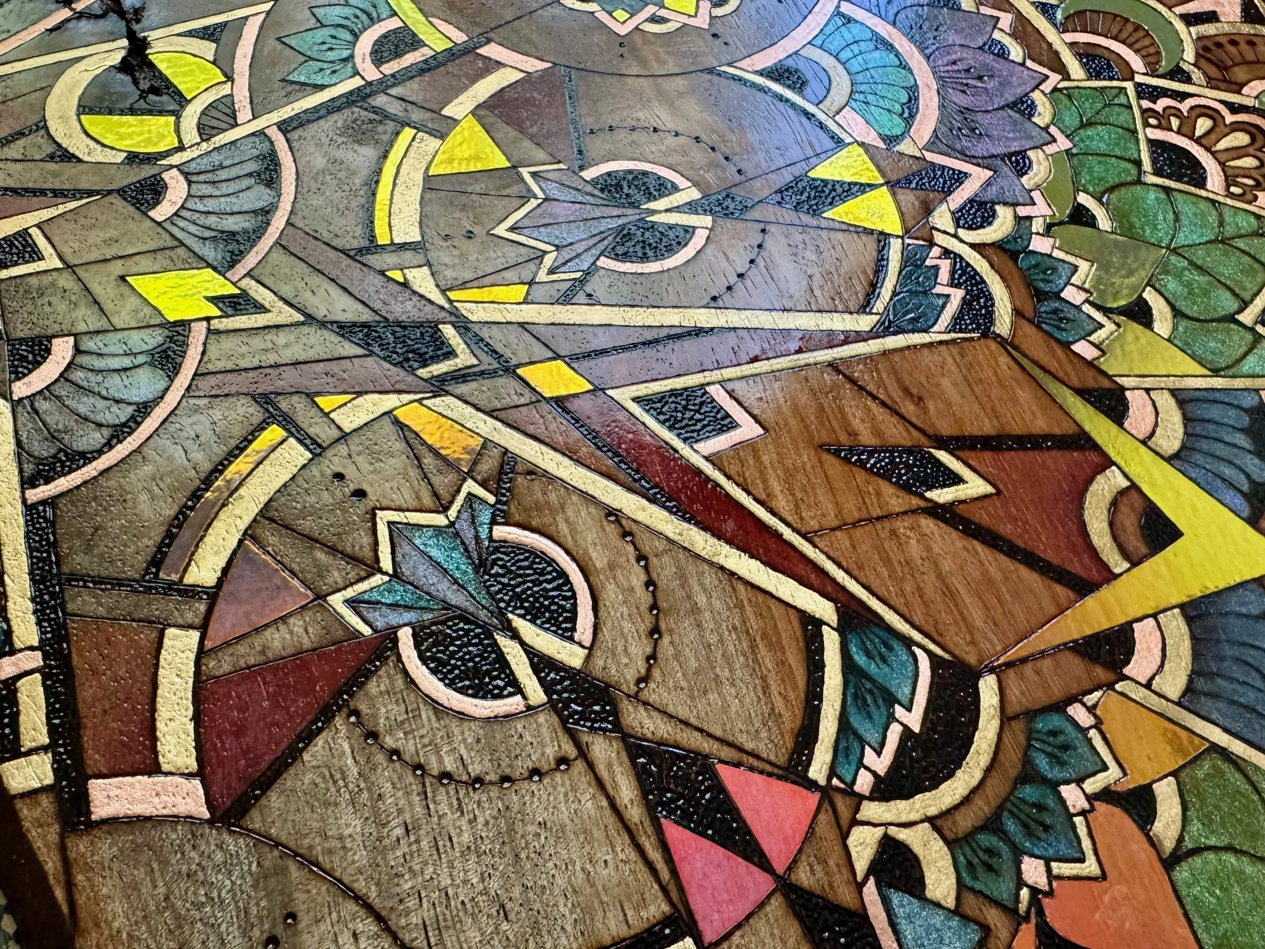 Gold ink detail with sacred patterning and vibrant color, woodburned geometric art.