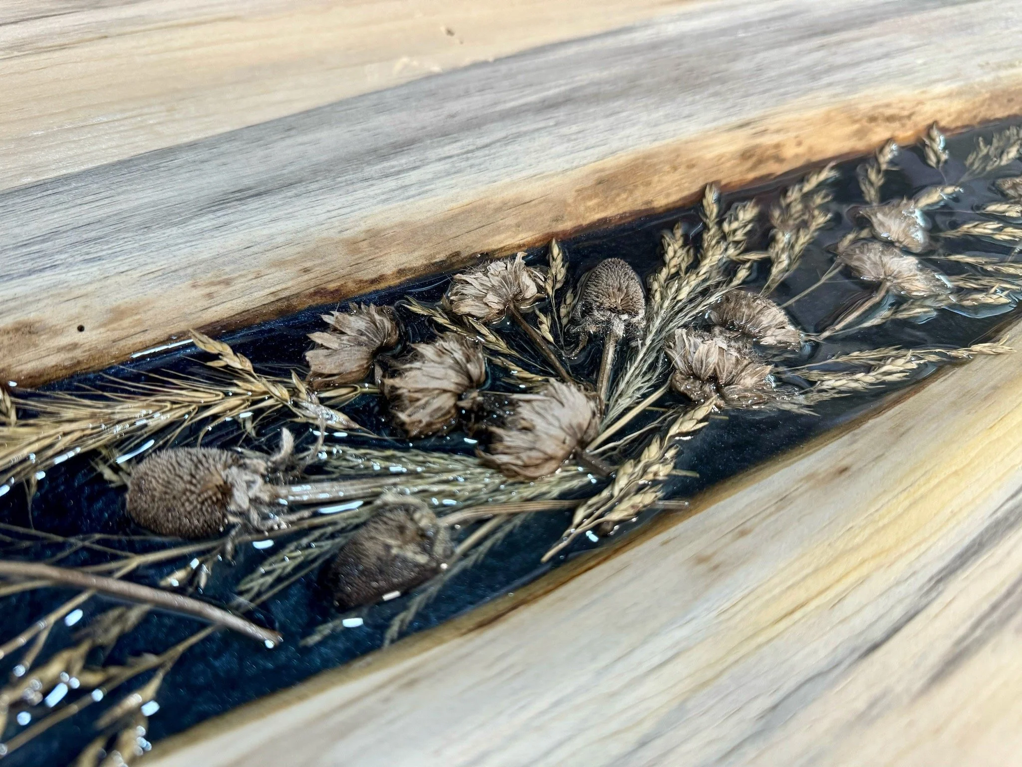 Beloved wall art by Anne Shackelford, incorporating flowers, grass, and natural pigments.