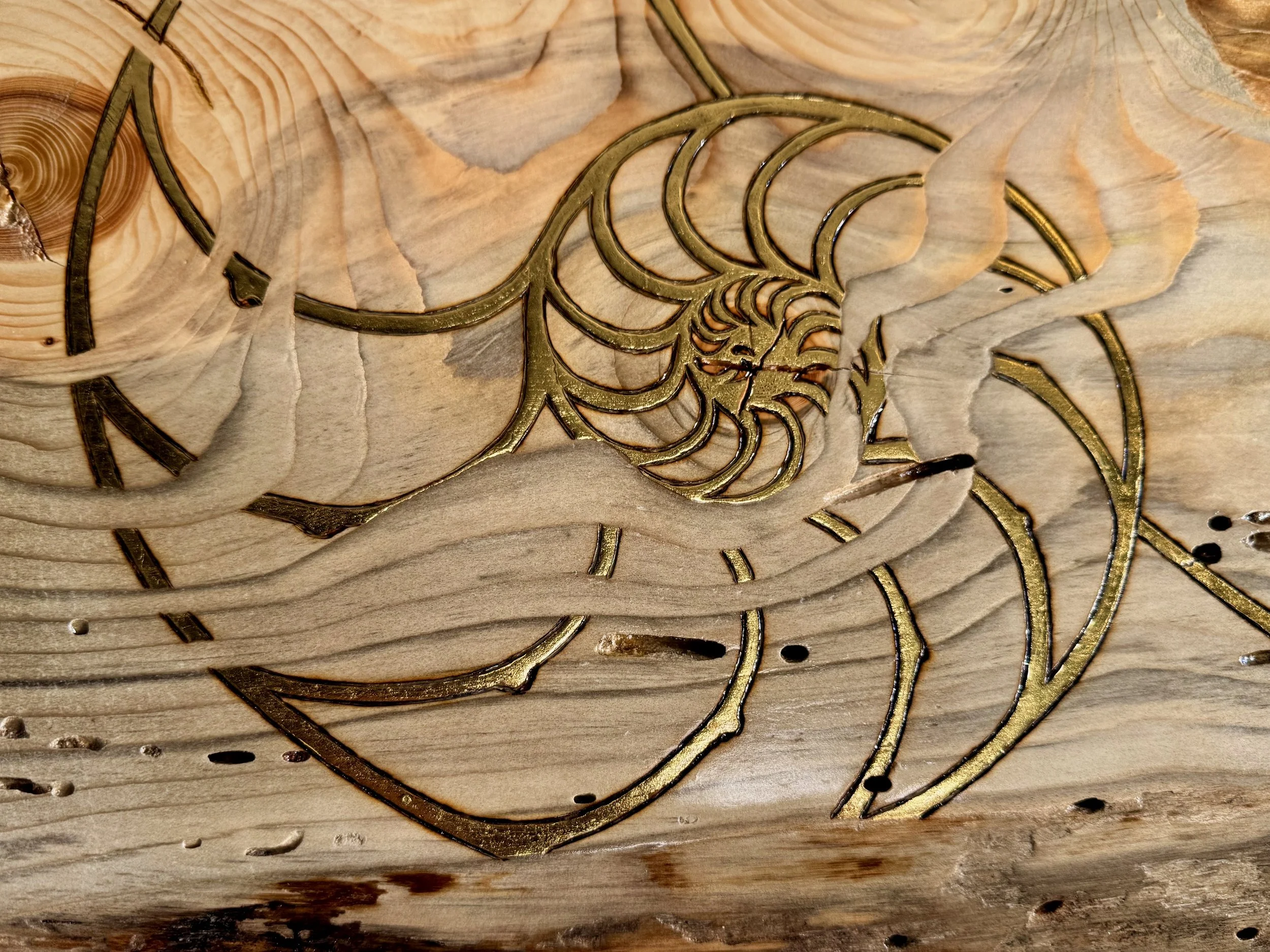 Nature-inspired Lovers Carvings wall art by Austin artist Anne Shackelford, resin and gold leaf on wood.