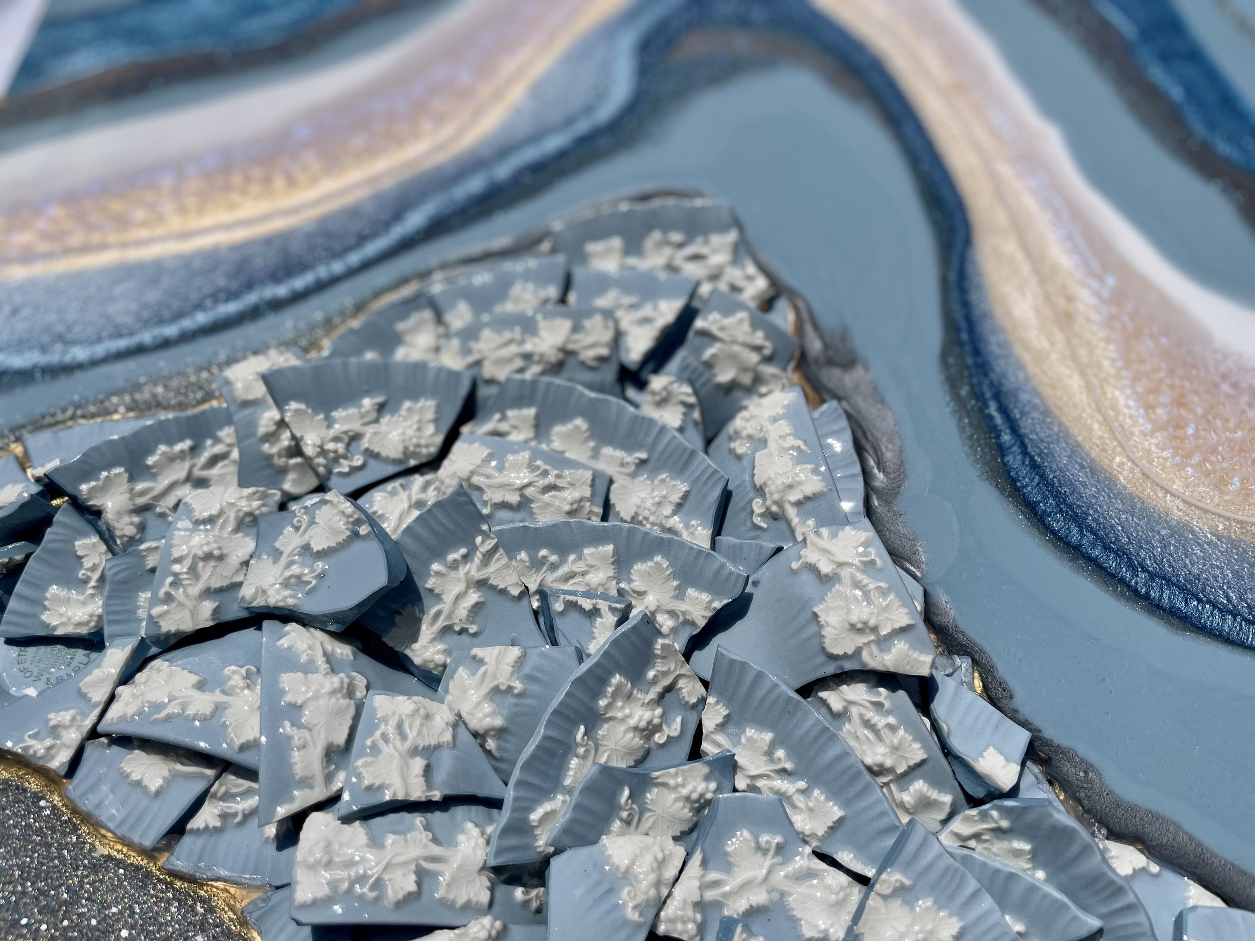 Resin wall art incorporating family china and reflective surface