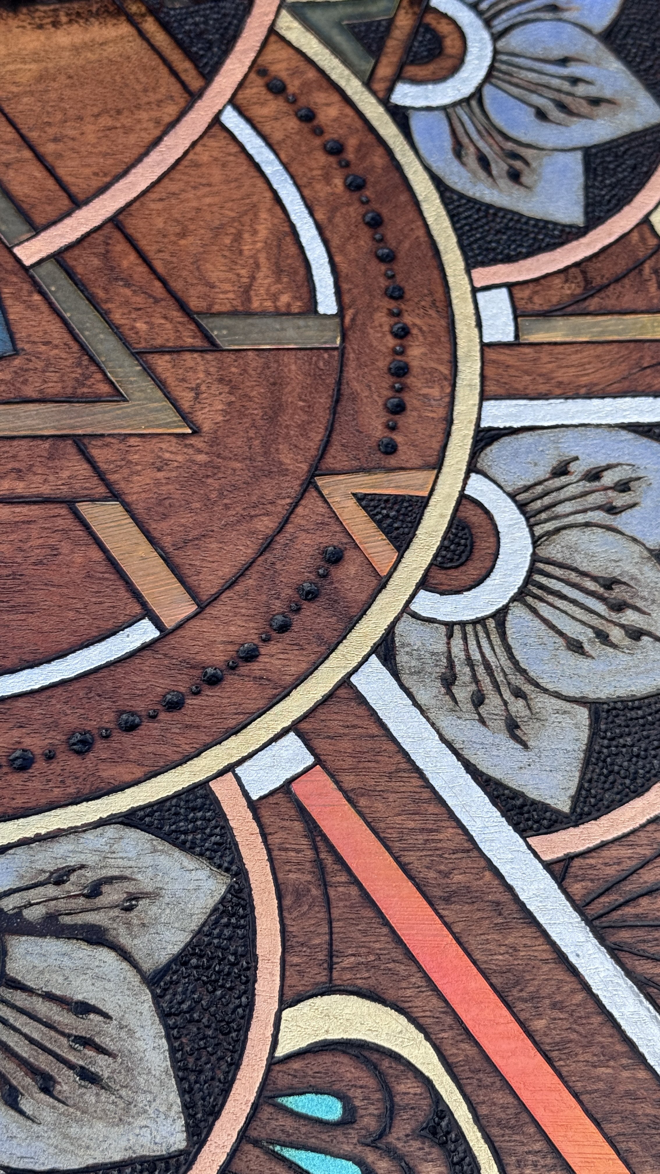 Detail view of Alchemy of Becoming, a large mixed media mandala artwork by Austin artist Anne Shackelford featuring pyrography and geometric patterning.