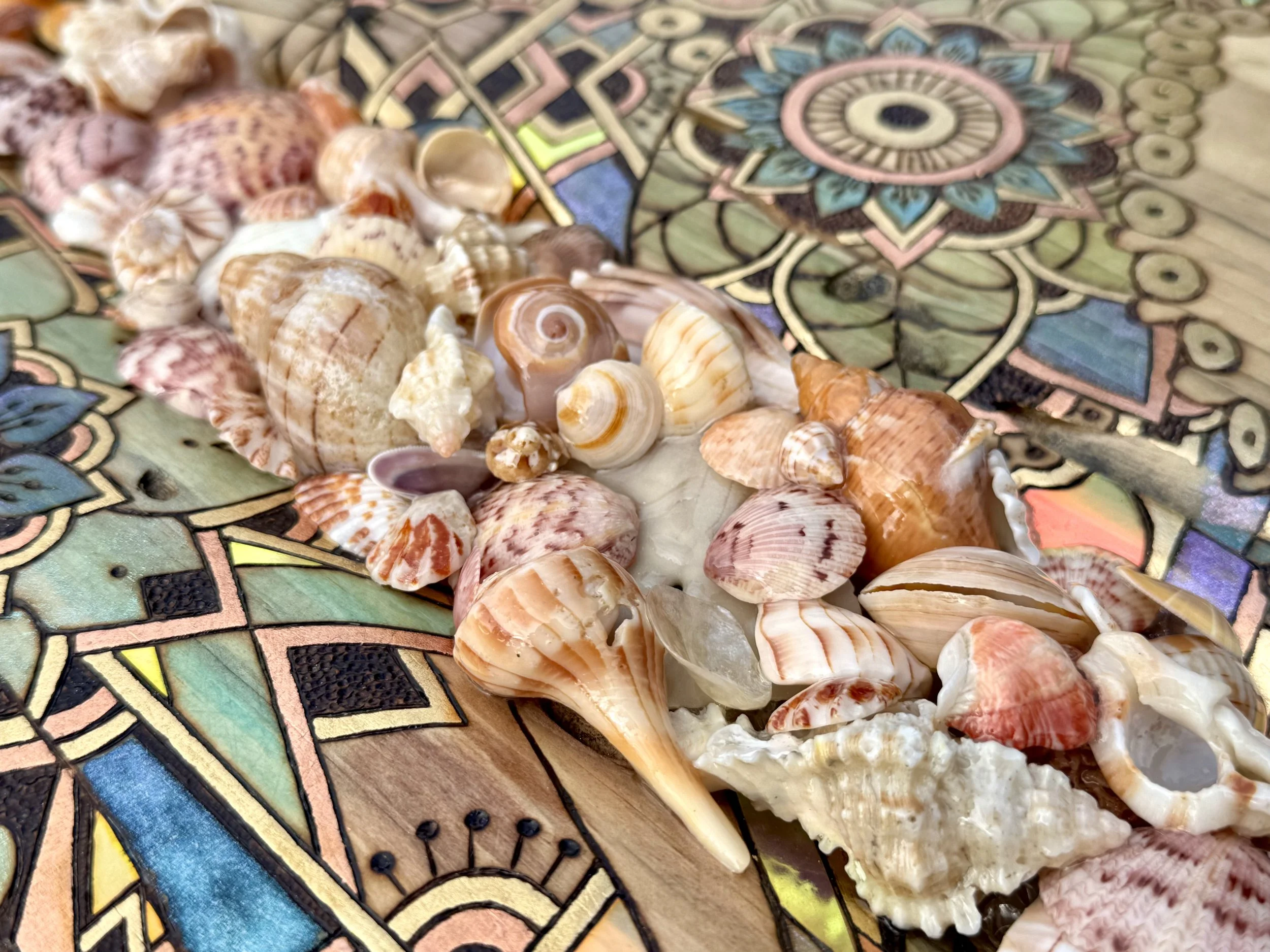 Glossy holographic elements give depth and shimmer to this mixed media pyrography wall piece.