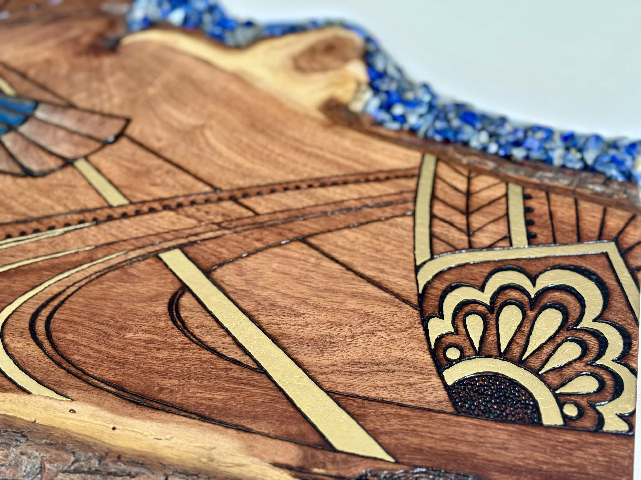 Scarab inspired wall art representing transformation, created with fire and natural materials