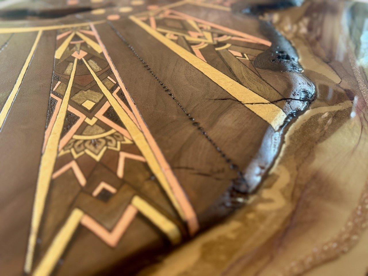Wall art featuring a sun and shining rays, crafted from resin and walnut.