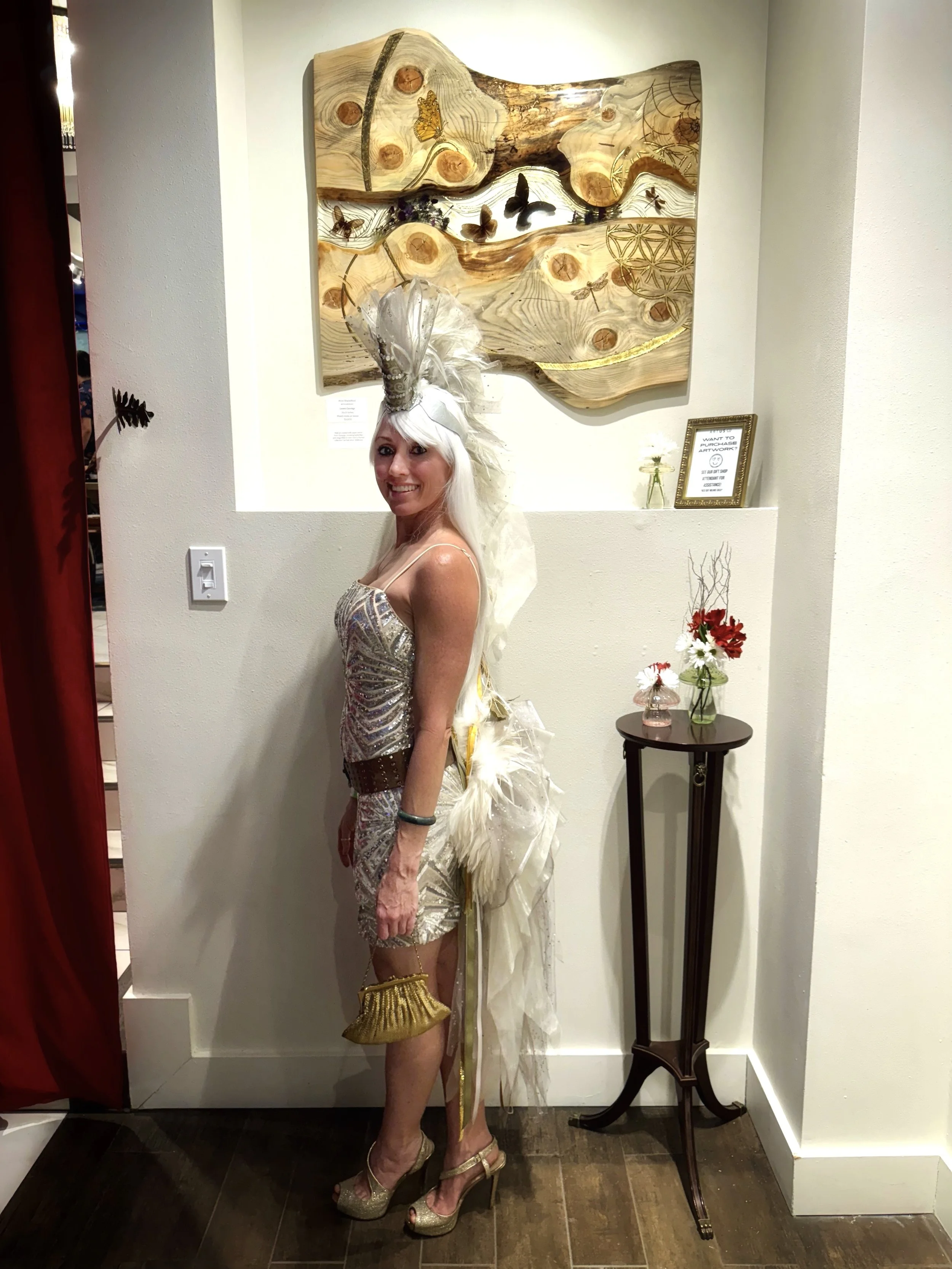 Austin artist Anne Shackelford with Lovers Carvings mixed media wall art created with aspen, resin, and gold leaf.