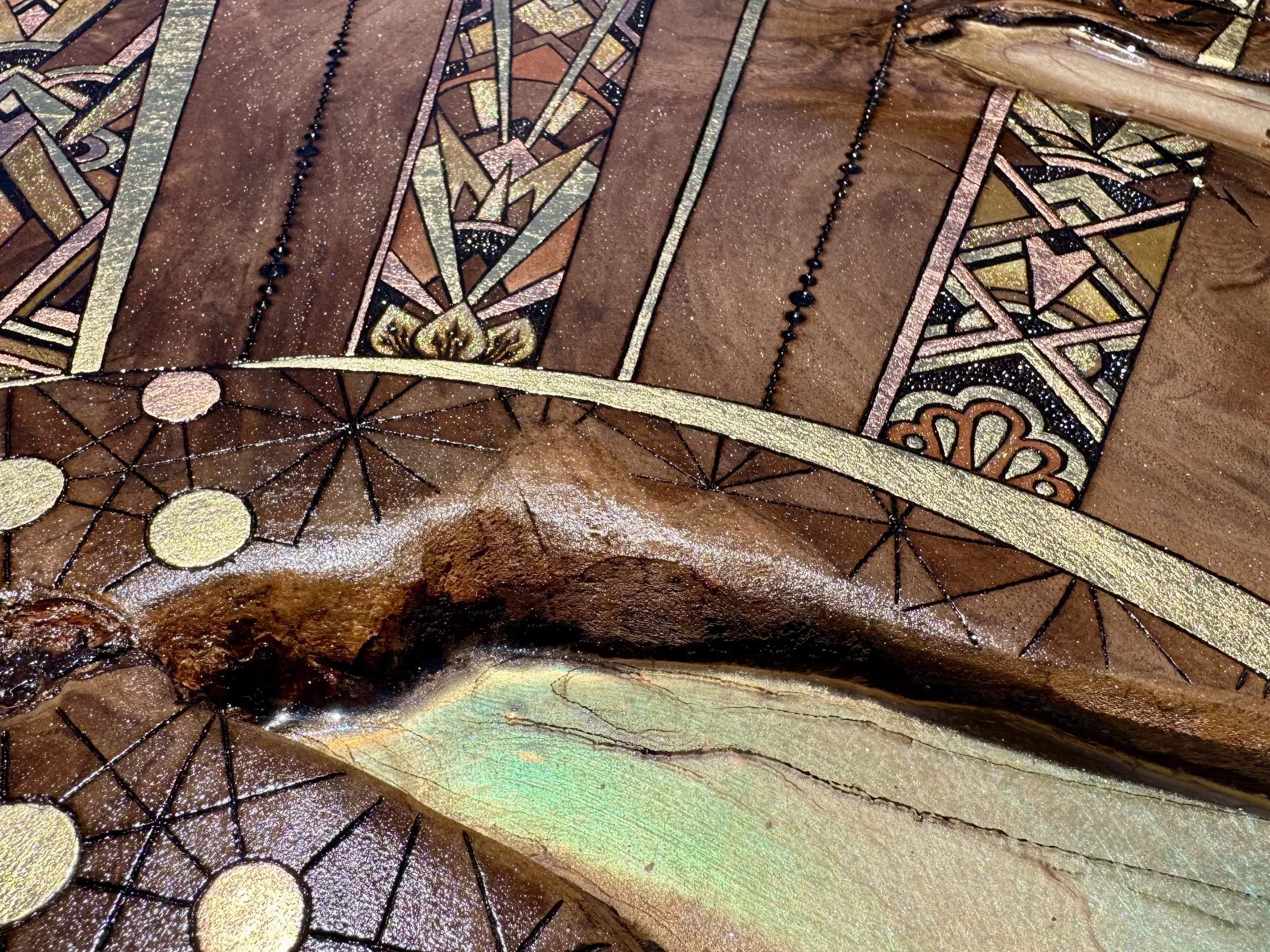 Symbolic sun wall art with warm tones and reflective surface