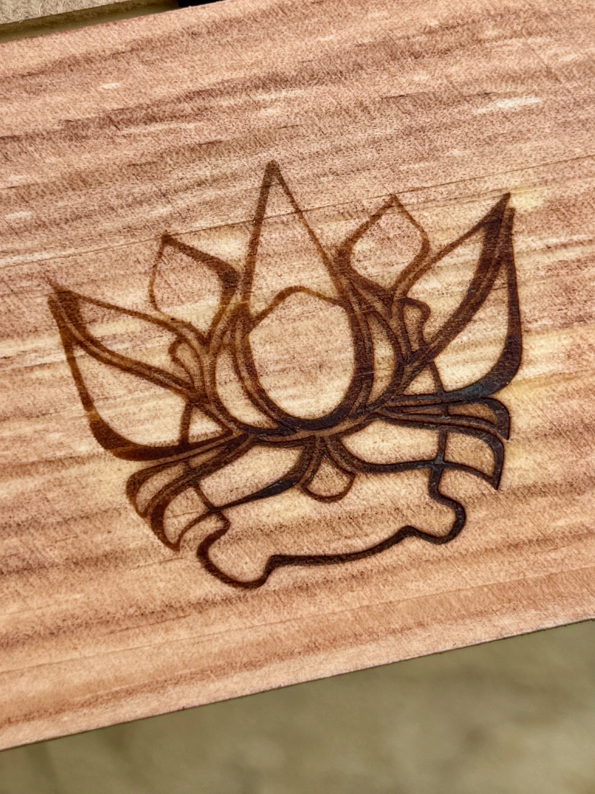 Close-up of Firelight Frame showing hand-burned pyrography detail.