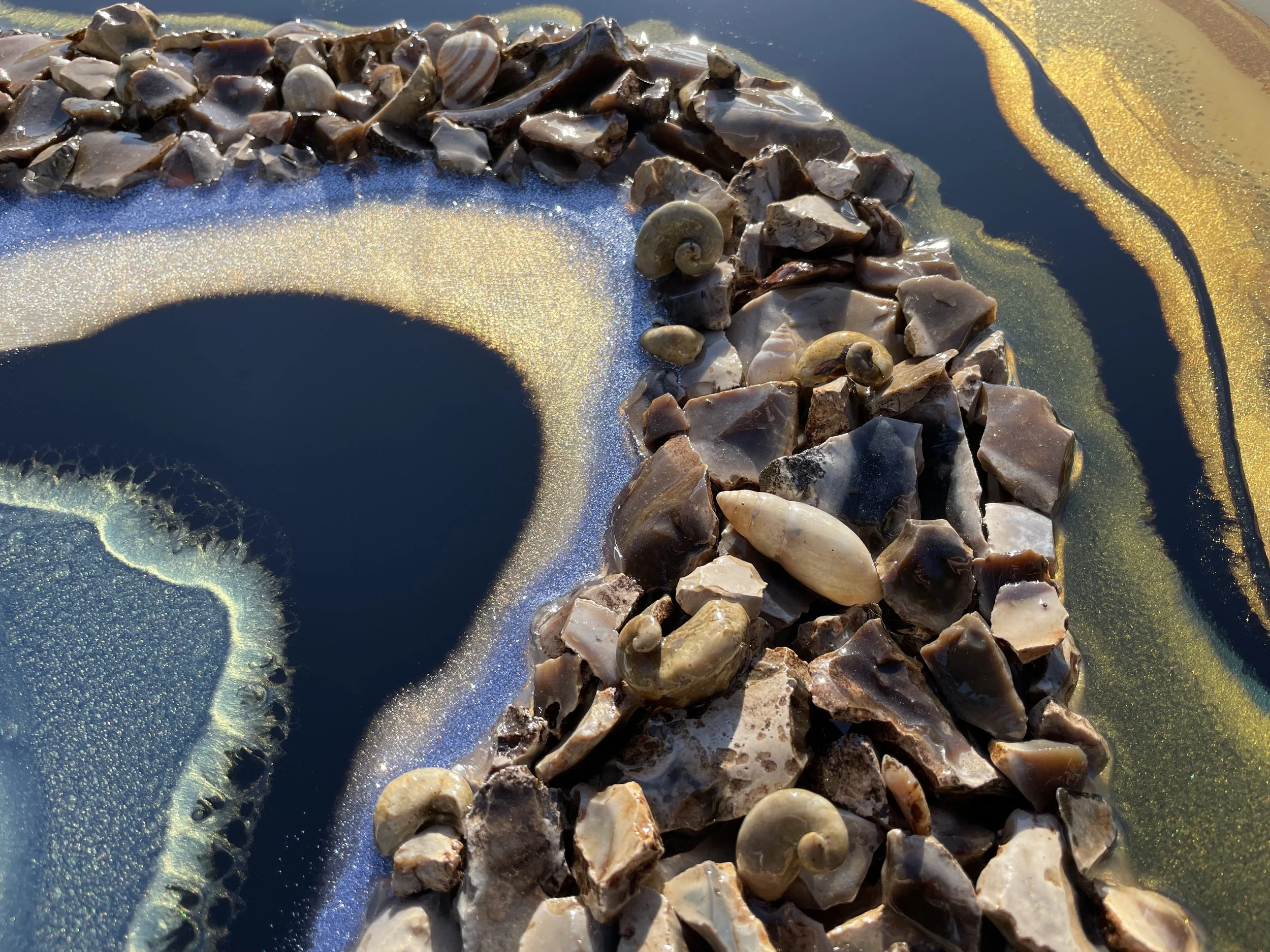 Natural elements wall art with flint, fossils, and gold leaf