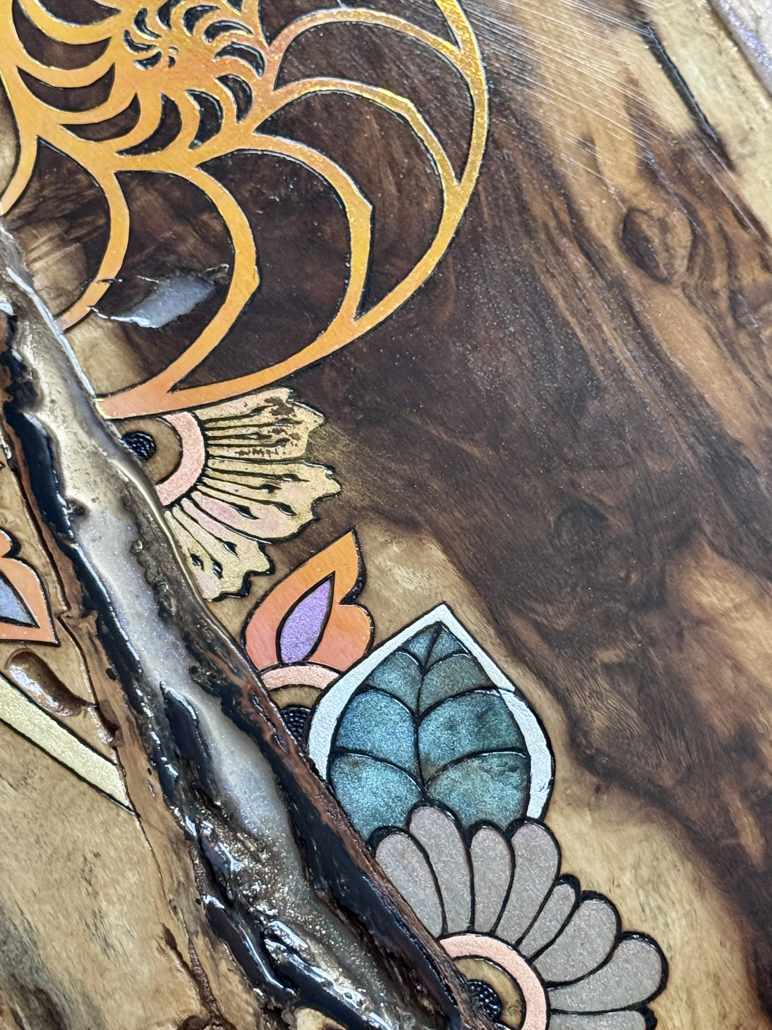 Detail of geometric and botanical patterns with reflective color layered alongside the natural grain of Texas wood.