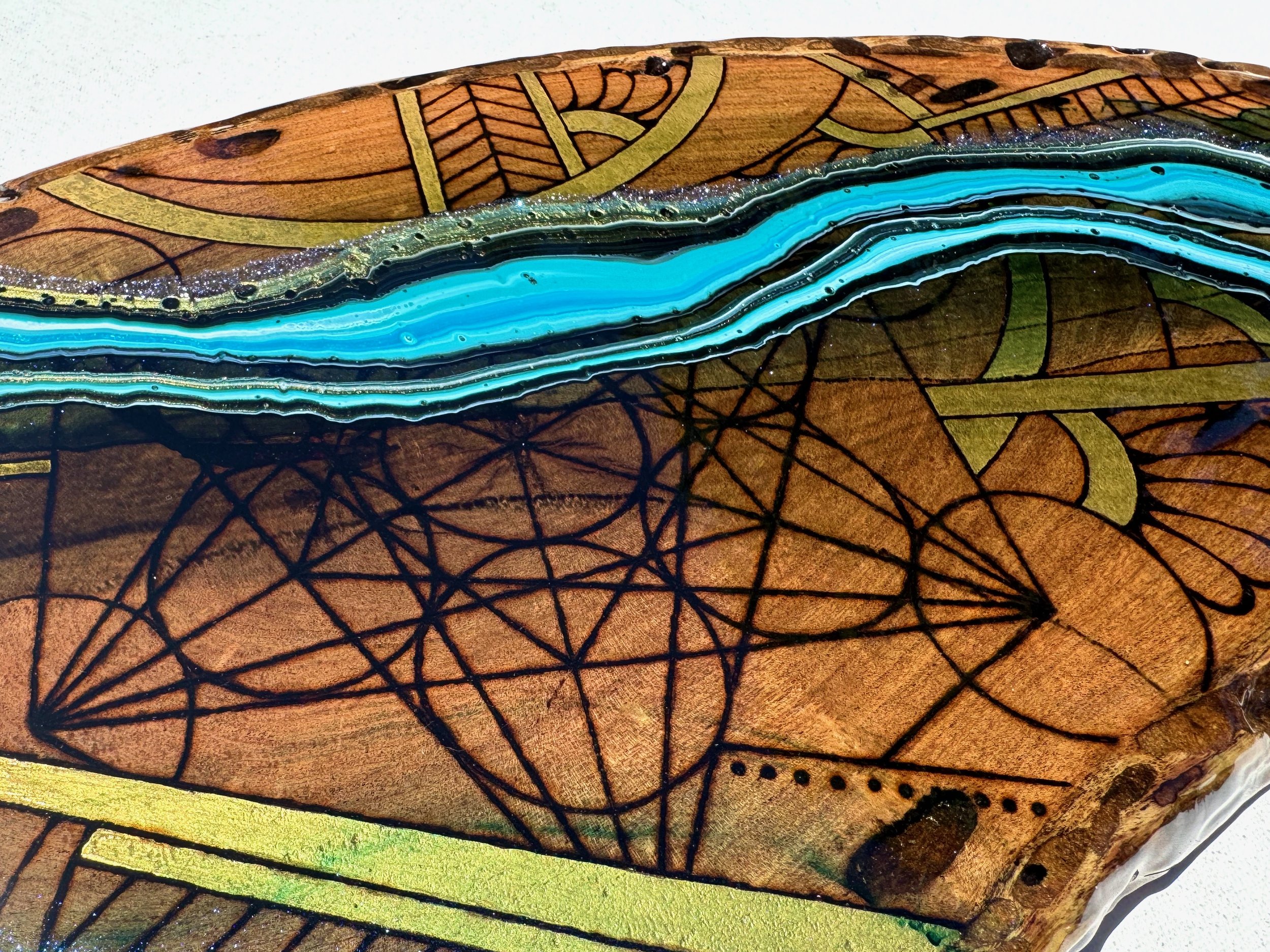 Mixed media functional artwork Replenish by Anne Shackelford, mesquite with resin glow.