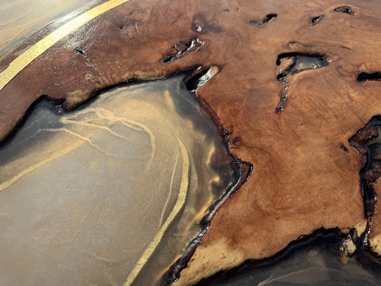 Golden reflections move across resin layers, revealing wood grain and pyrography beneath in Islands in the Sun.