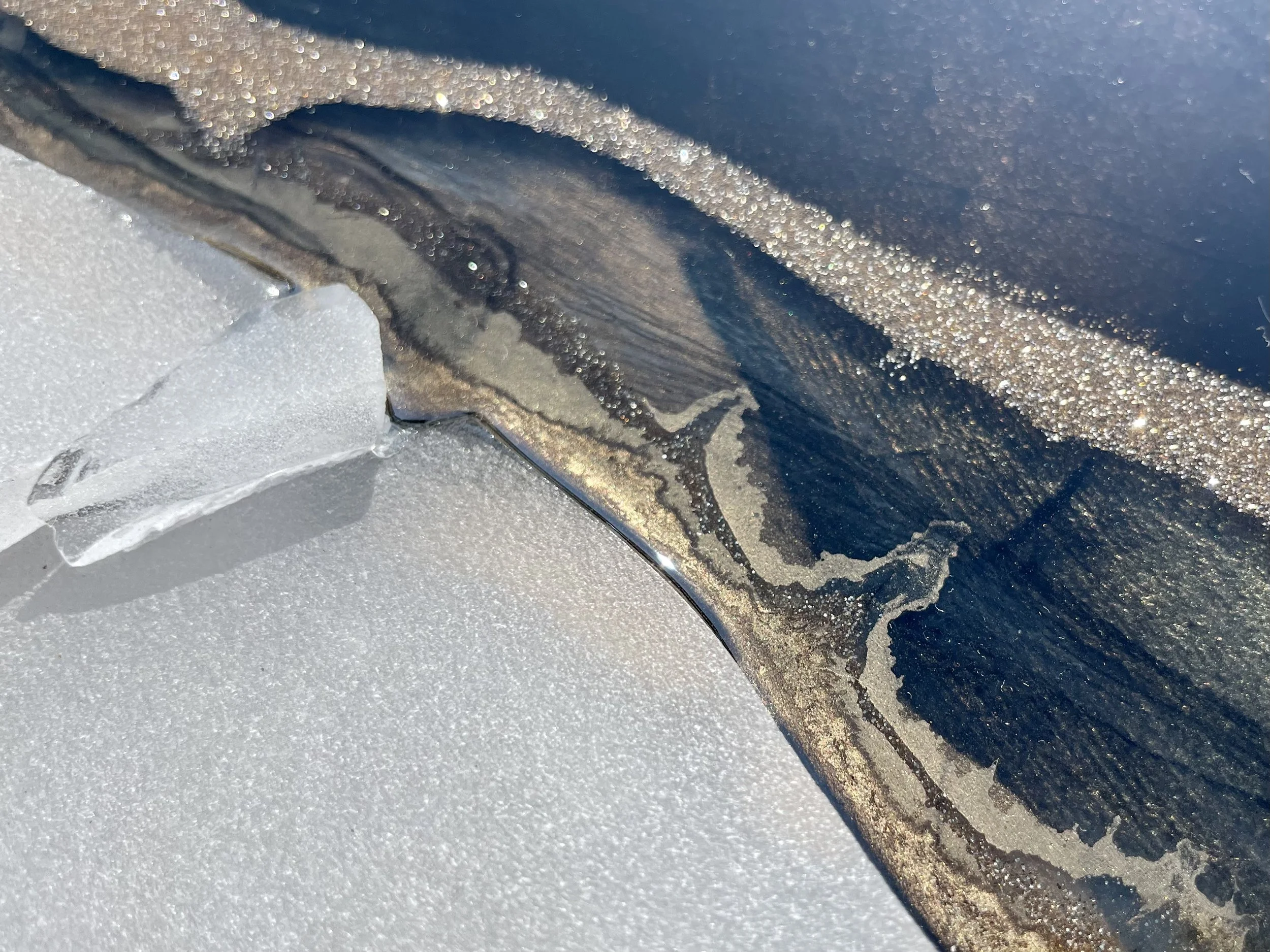 Detail view of mixed media wall art with gold leaf and alcohol ink