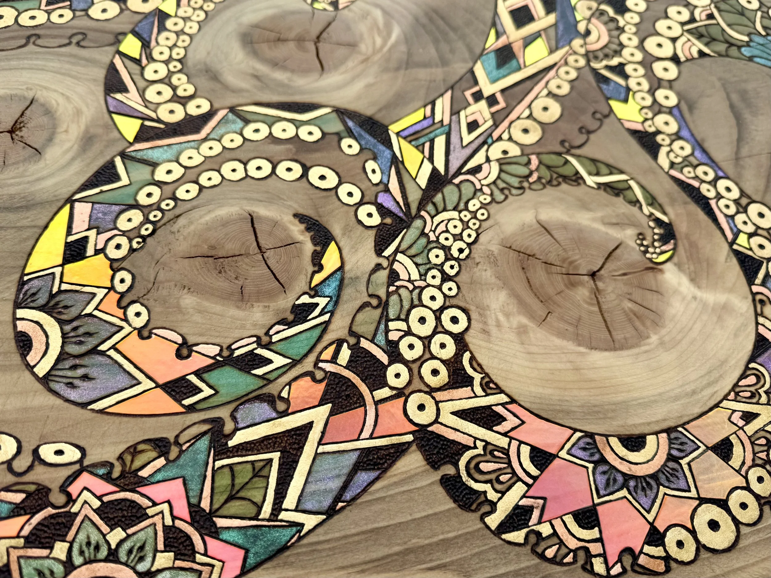 Ethereal shimmer catches the eye in this handmade pyrographic wood artwork with spiritual undertones.