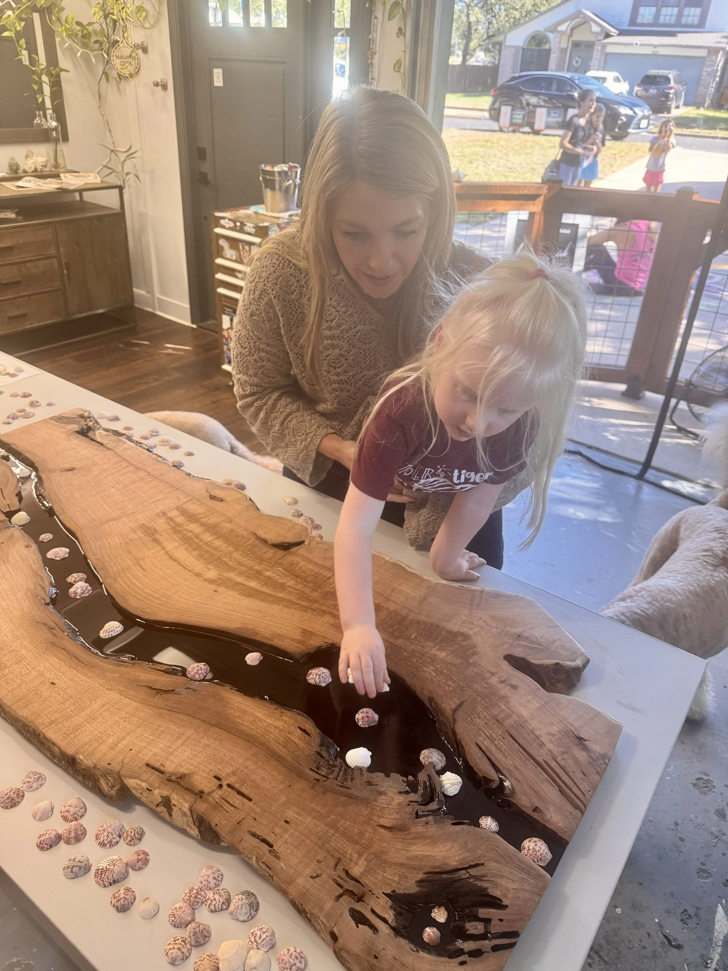 Guests contribute shells to The Collective Current, shaping the final form of this interactive functional art piece.