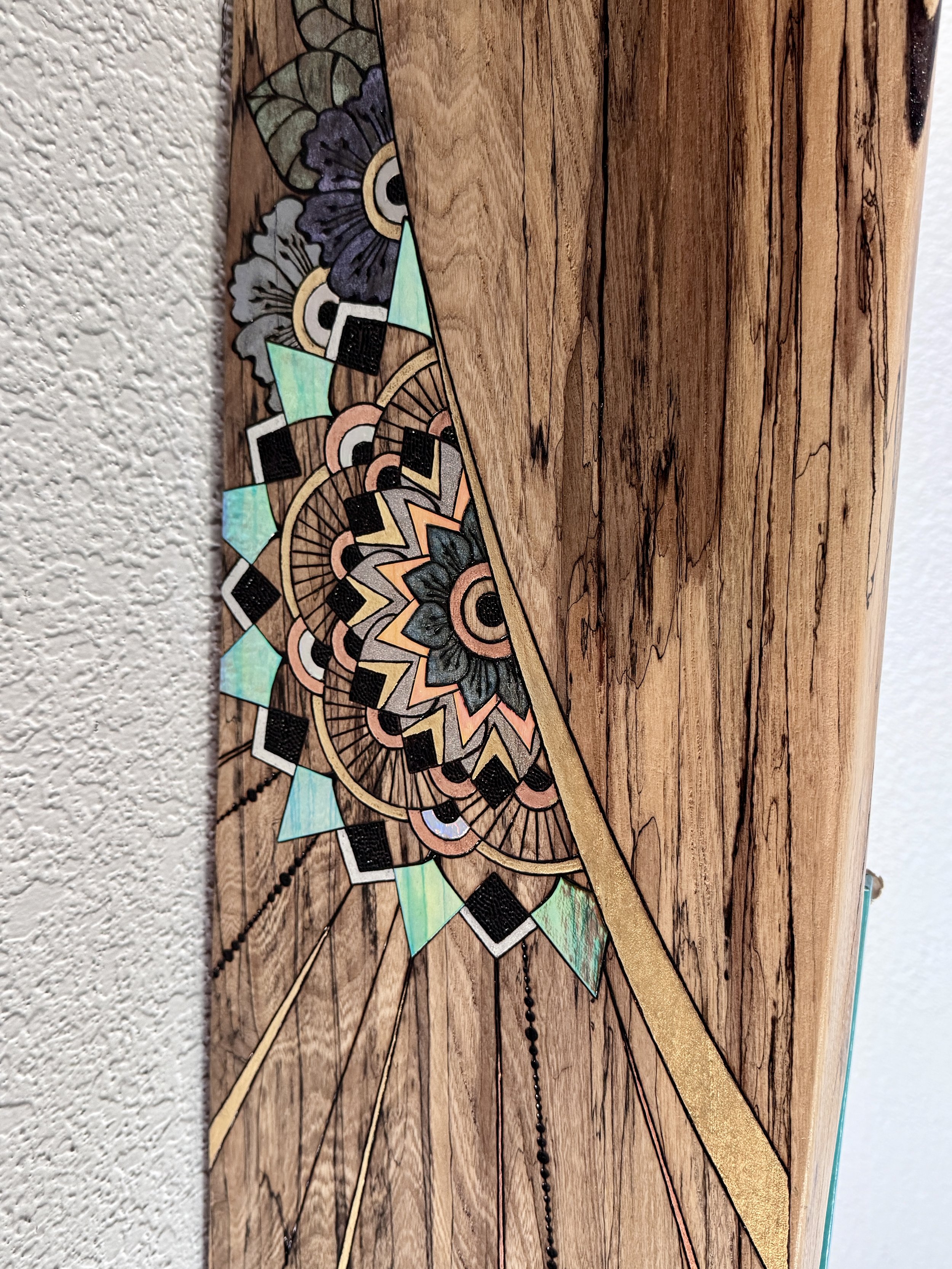 Close-up of the hand-burned artwork on Storyteller by Anne Shackelford, revealing intricate pyrography on live-edge Texas pecan.