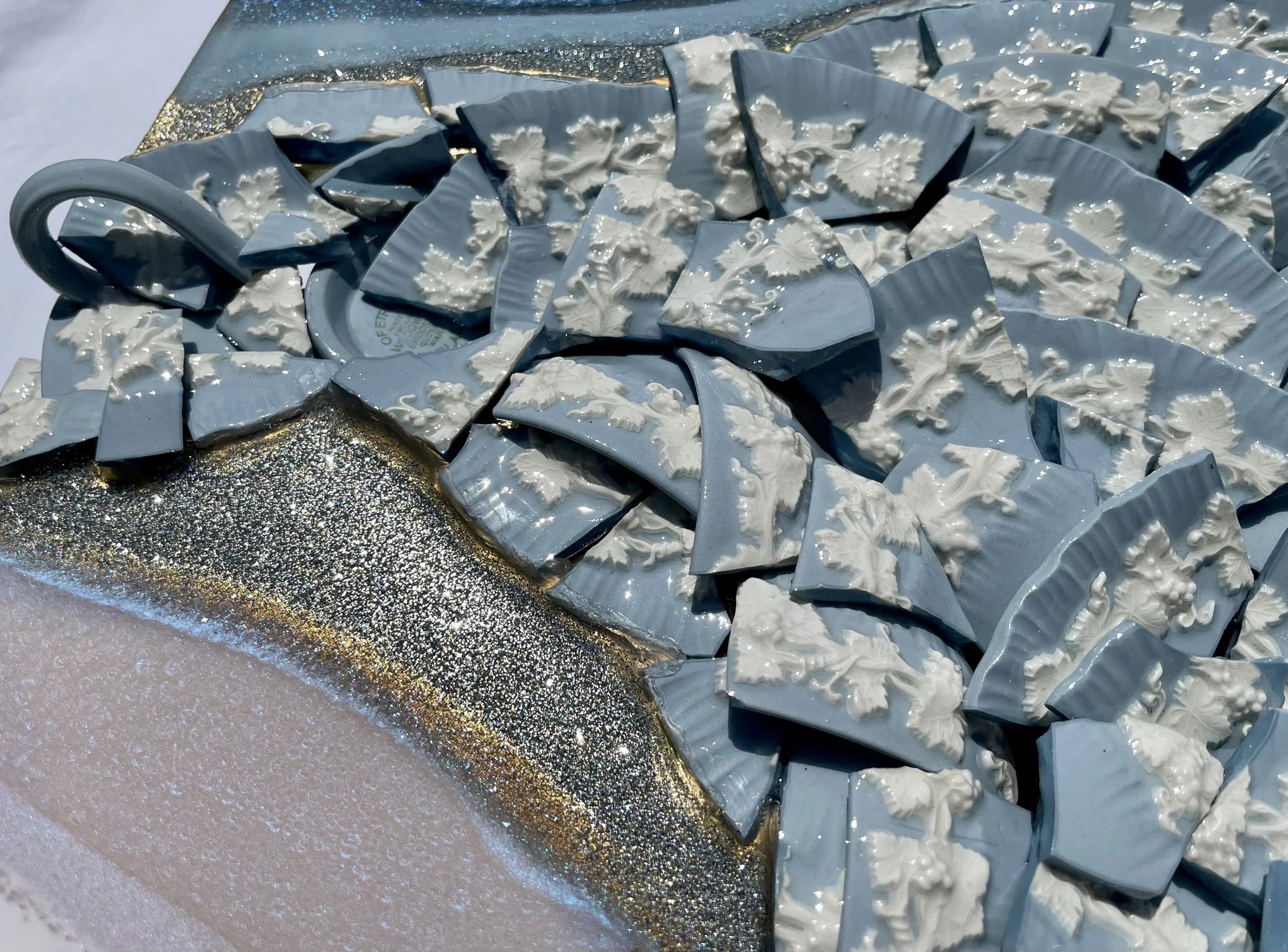 Heirloom china wall art transformed into a new mixed media composition