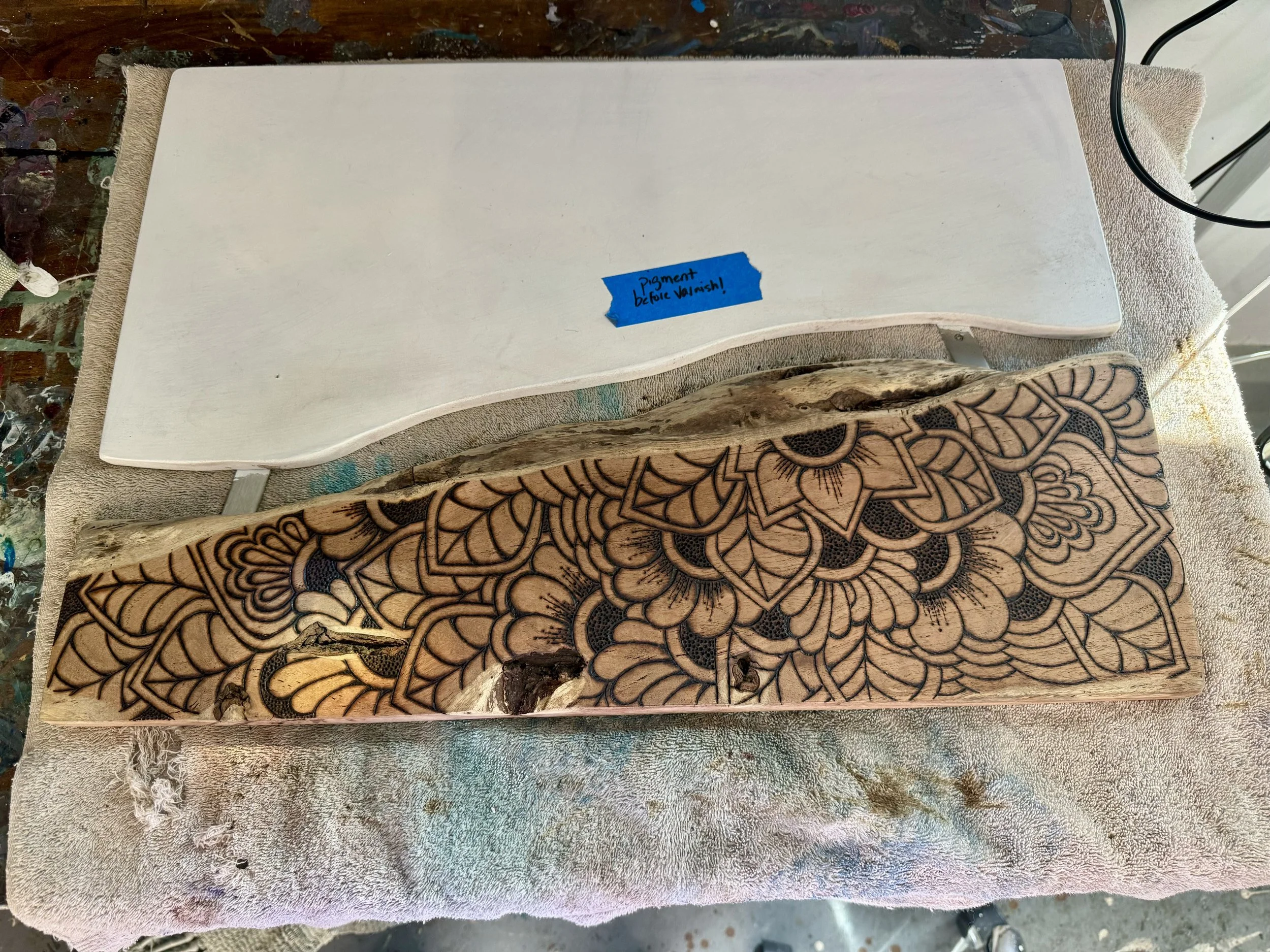 Elemental wall art created with pyrography, resin, and natural materials