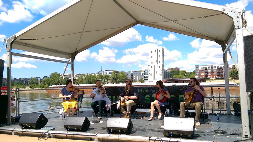 L to R: Rosa (fiddle), Keyreel Raskolenko (fiddle), Ryan Behnke (pipes), Cara Wildman (bodhran), Buddy Ferrari (vocals/bouzouki) on the River Stage at the Minnesota Irish Fair