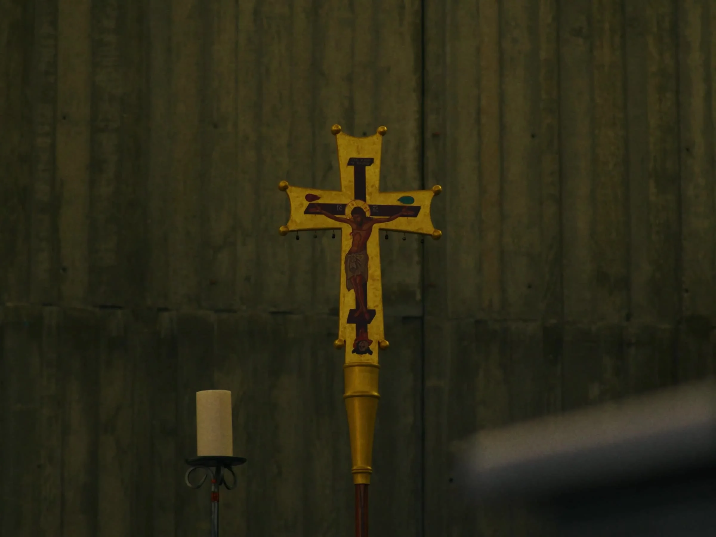 Processional crucifix in the Newman Hall chapel. Photo by @reagancalaguasfilm