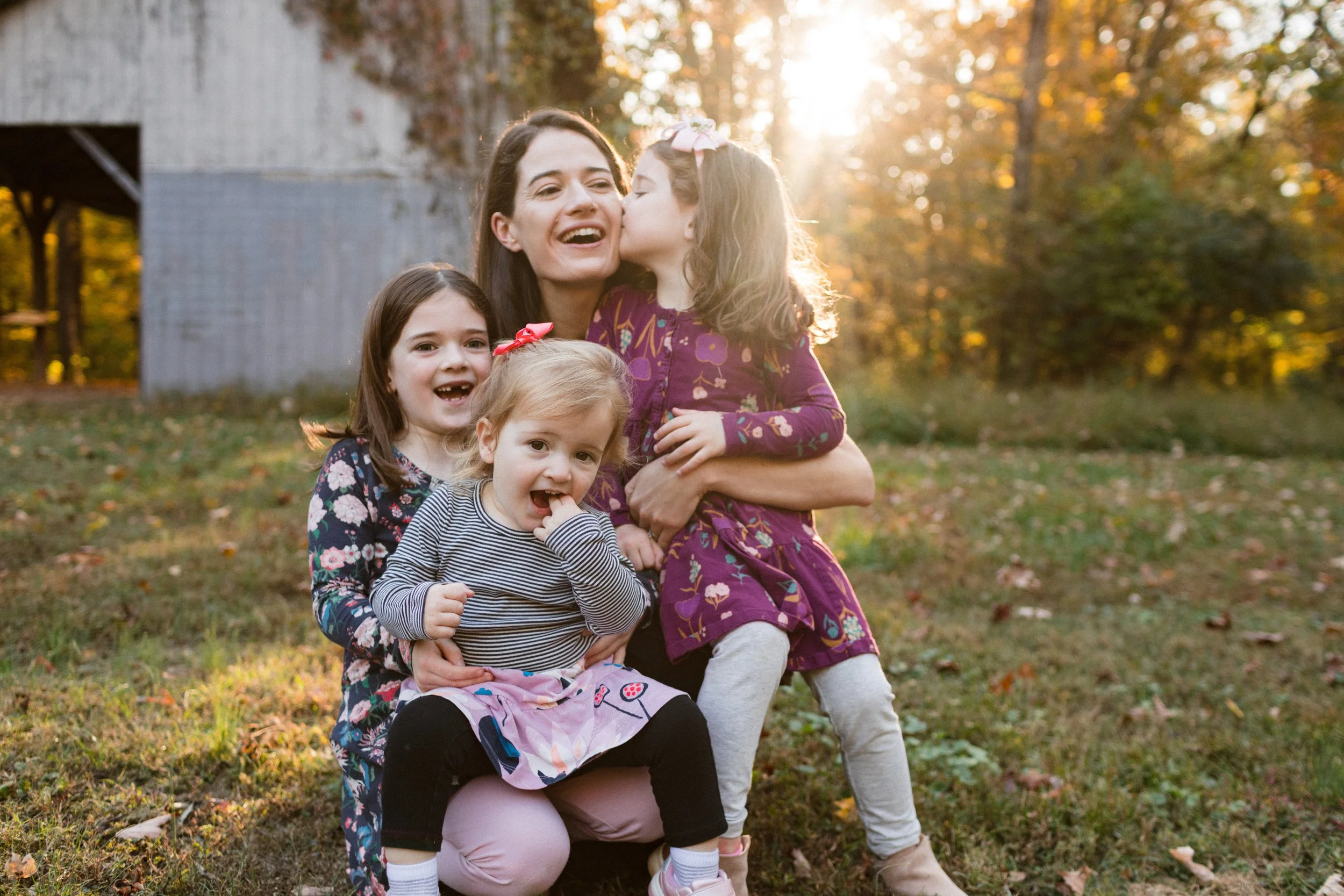 Durham family photographer captures family in coordinated fall outfits among autumn foliage.