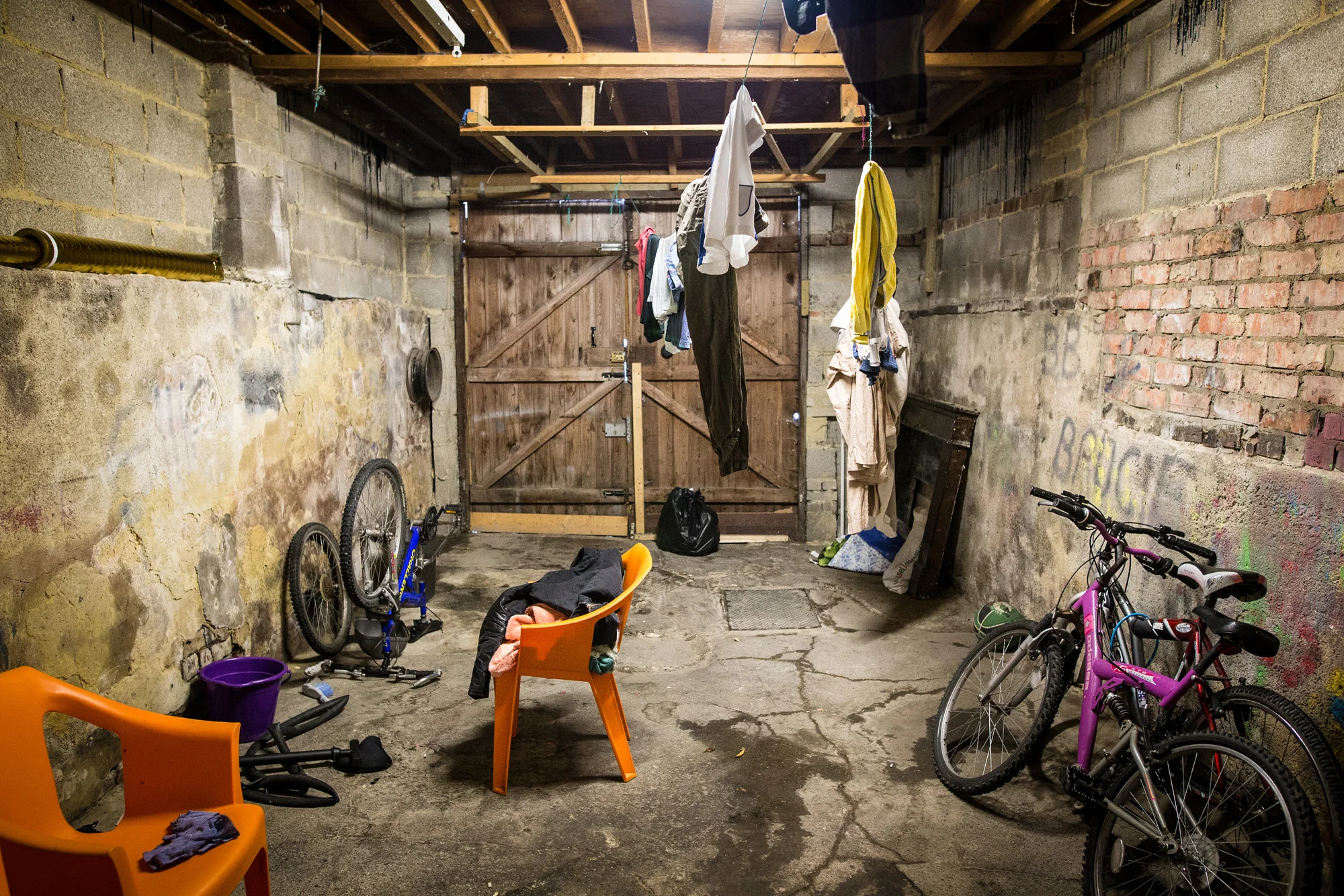 The garage at a refugee’s council flat in Harrogate, where he and his housemates dry their washing and maintain their bikes Photograph: Charlotte Maxwell for Point.51