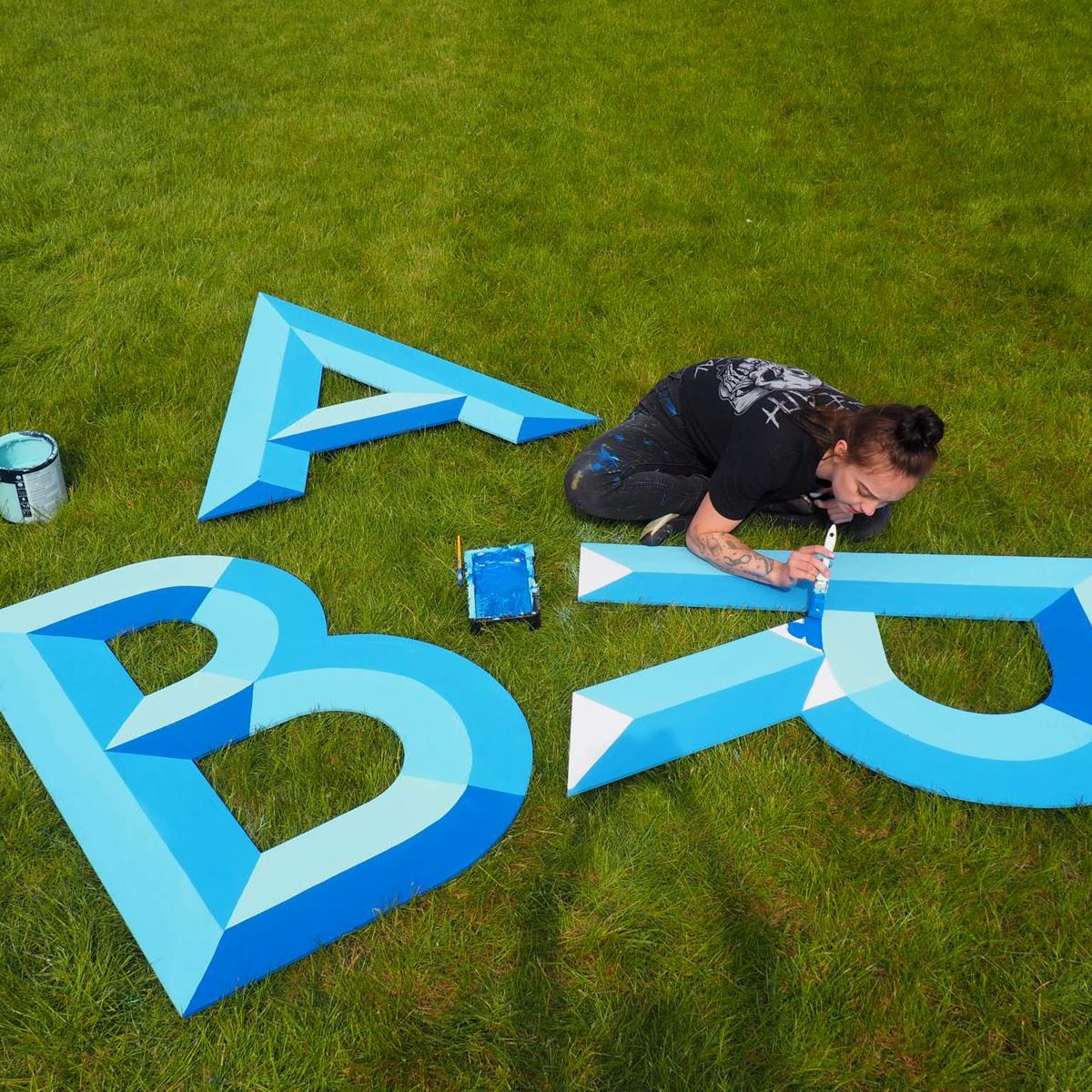 Large cut-out letters spelling 'BAR' hand-painted with a bevel design.