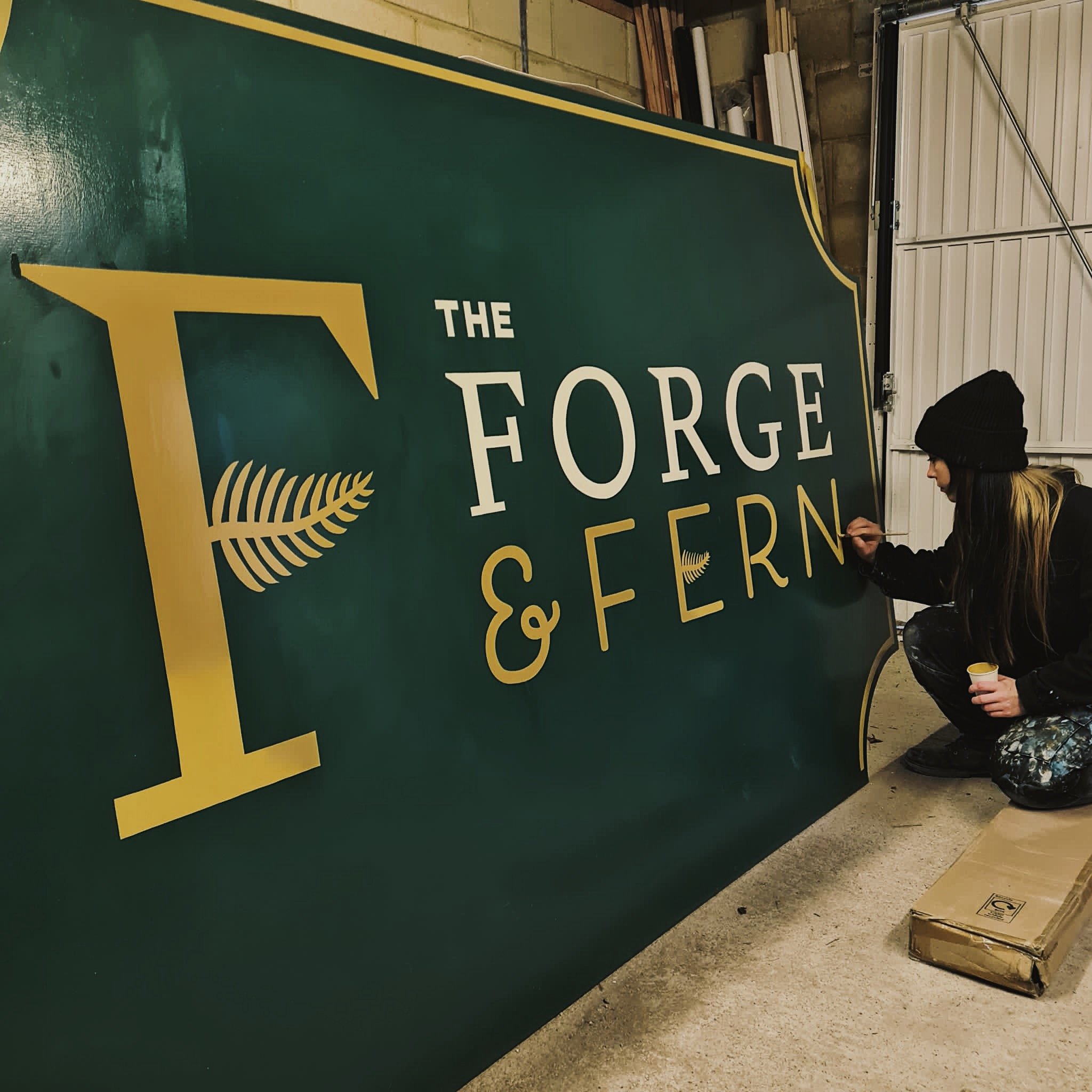 Painting progress of a sign for Bristol restaurant bar Forge and Fern.