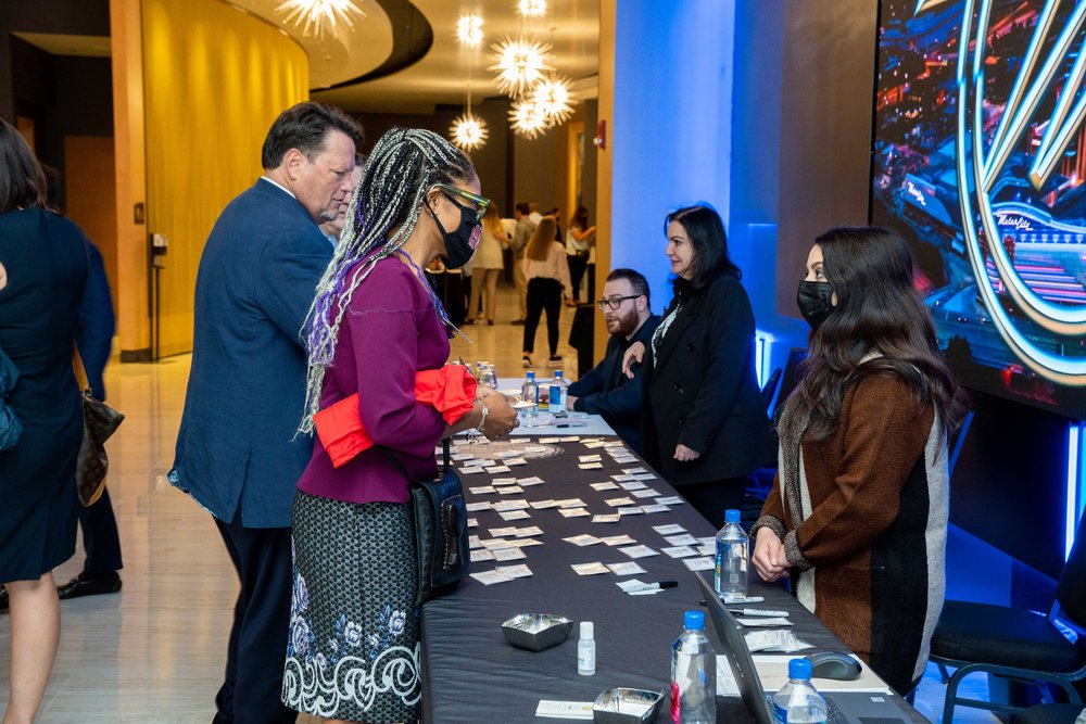 Guests checking in with staff (from right) Stacy Bahri, Carolin Hormis, and Sinan Taila
