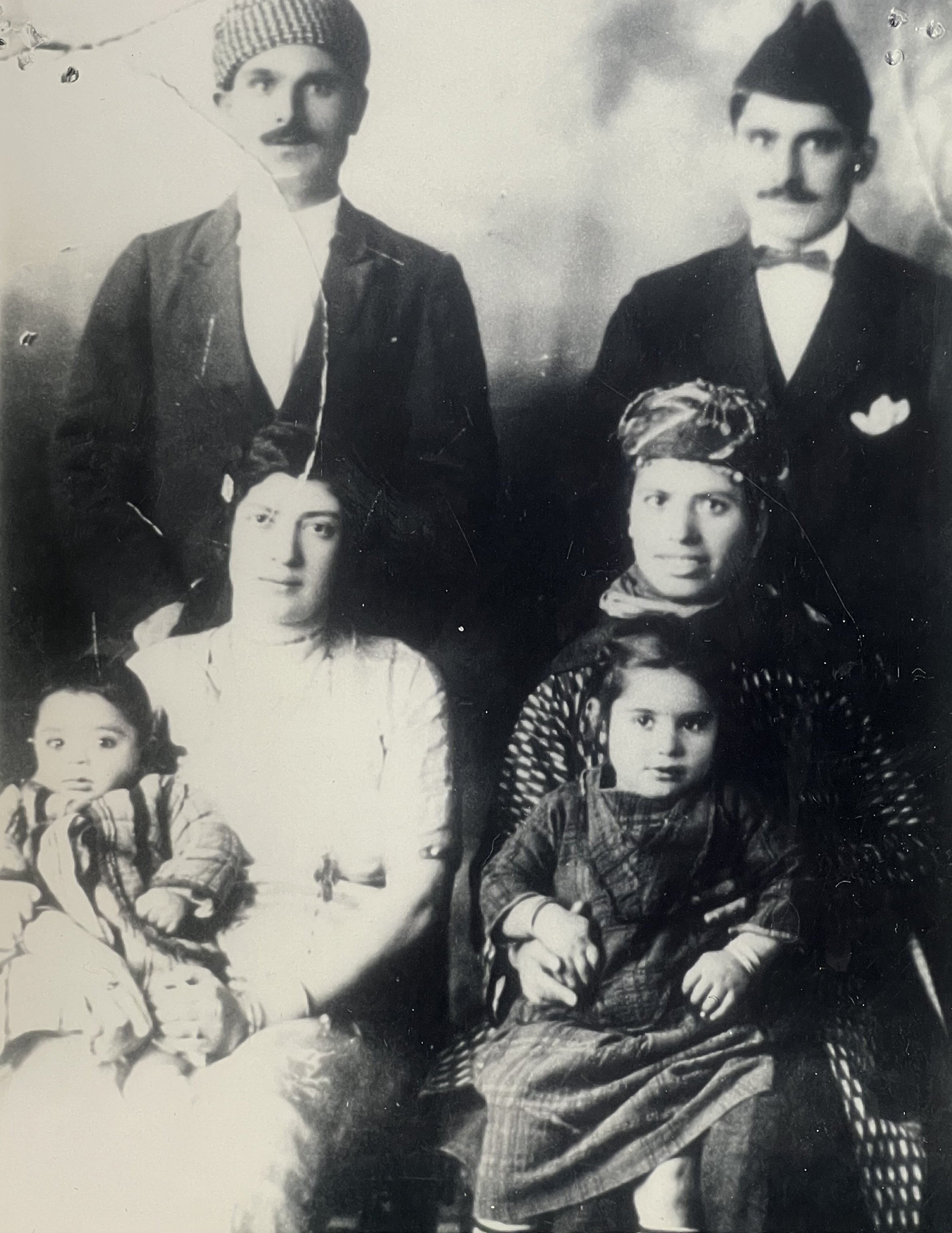 Ghazala George Qas Hanna carrying Rapheal Atto & Amina Roumaya carrying Mary Atto  Standing Hanna Rufa Atto & brother Tobia Rufa Atto 1925.jpeg