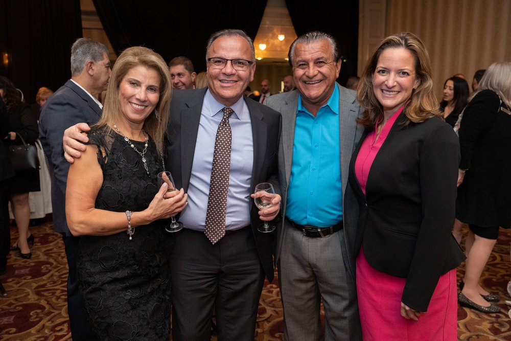  Sharkey Haddad stands next to Secretary of State Jocelyn Benson and another couple at the Gala. 