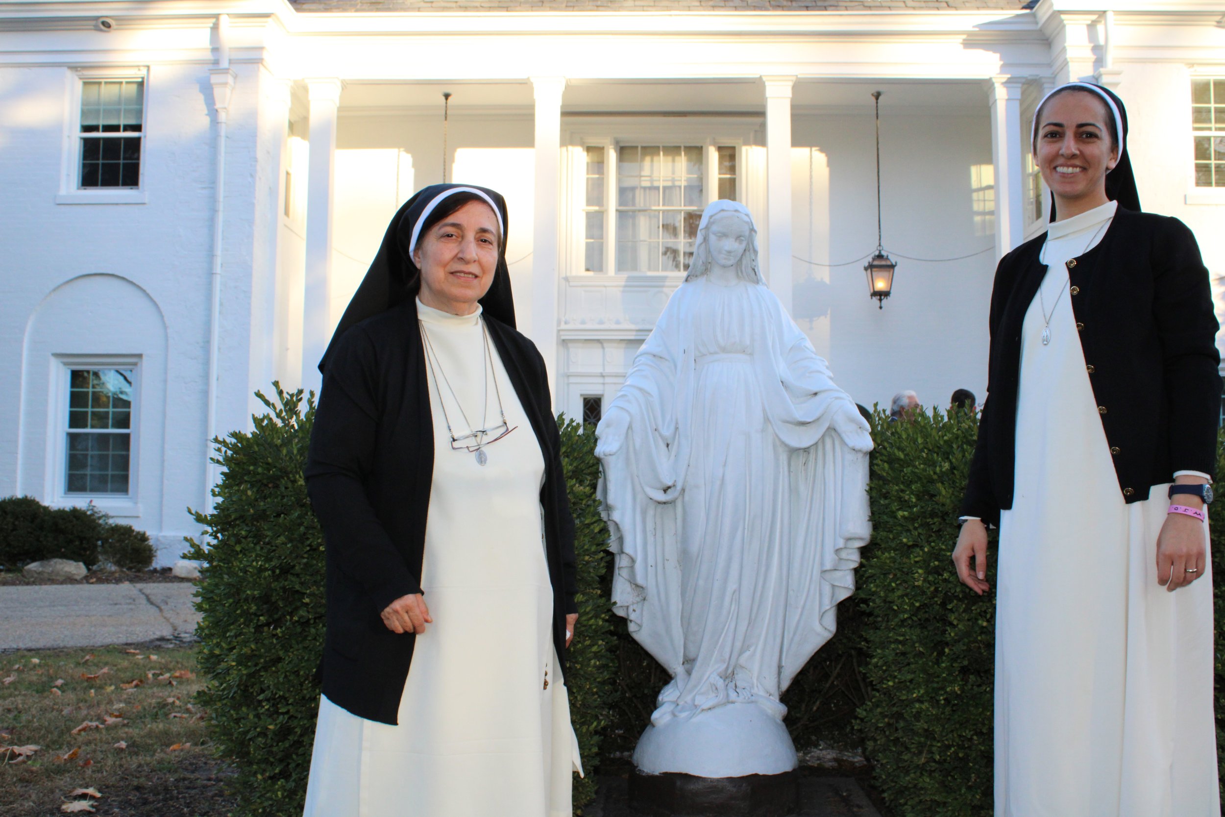  Sr. Ibtihaj Kirma and Sr. Amanda Foumia stand by a statue of the Blessed Mother at the entrance of the retreat center.  