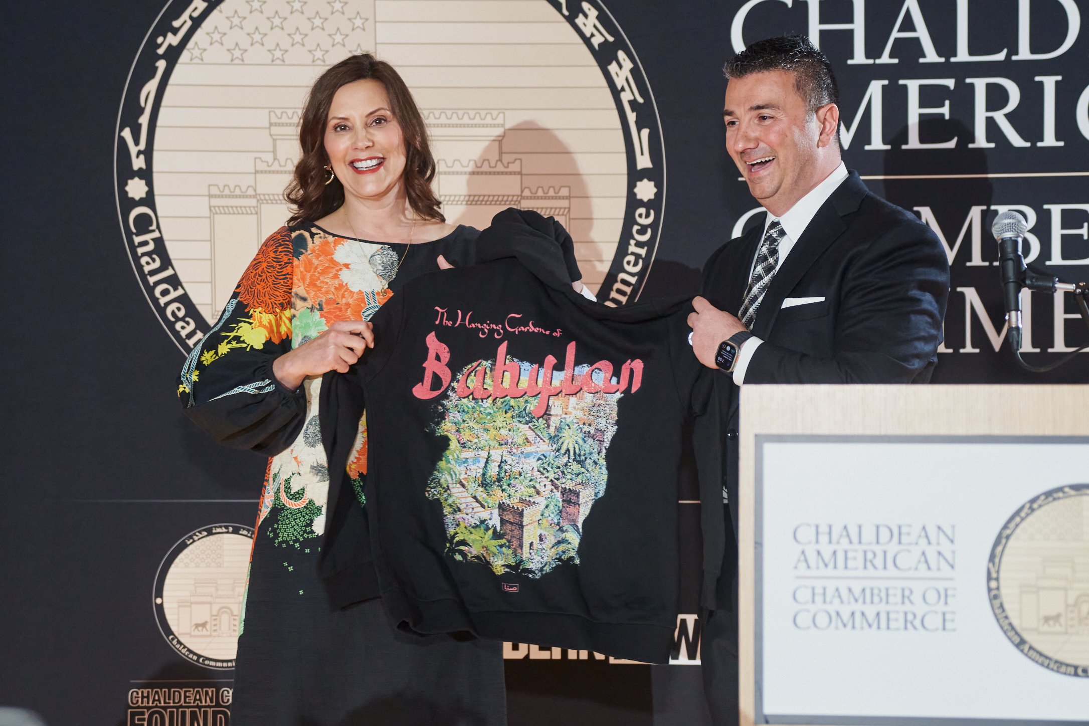  CACC and CCF President Martin Manna presents to Gov. Gretchen Whitmer a hoodie specially designed by Michael Sana of SANA Detroit for the Chamber’s 20th year. 