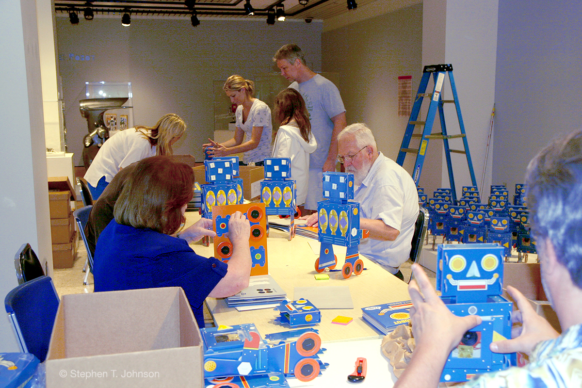 Volunteers building 100 Robots.