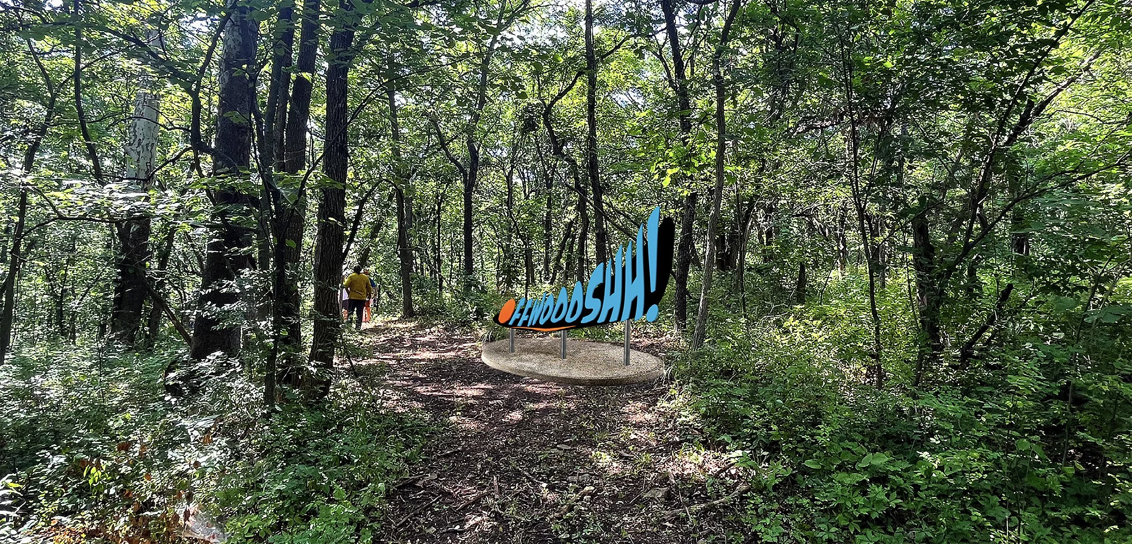  The unexpected wordplay introduces a comical moment along the wooded path, transforming the fleeting sound and movement of a thrown disc into a physical form that visitors encounter as they move through the course. 