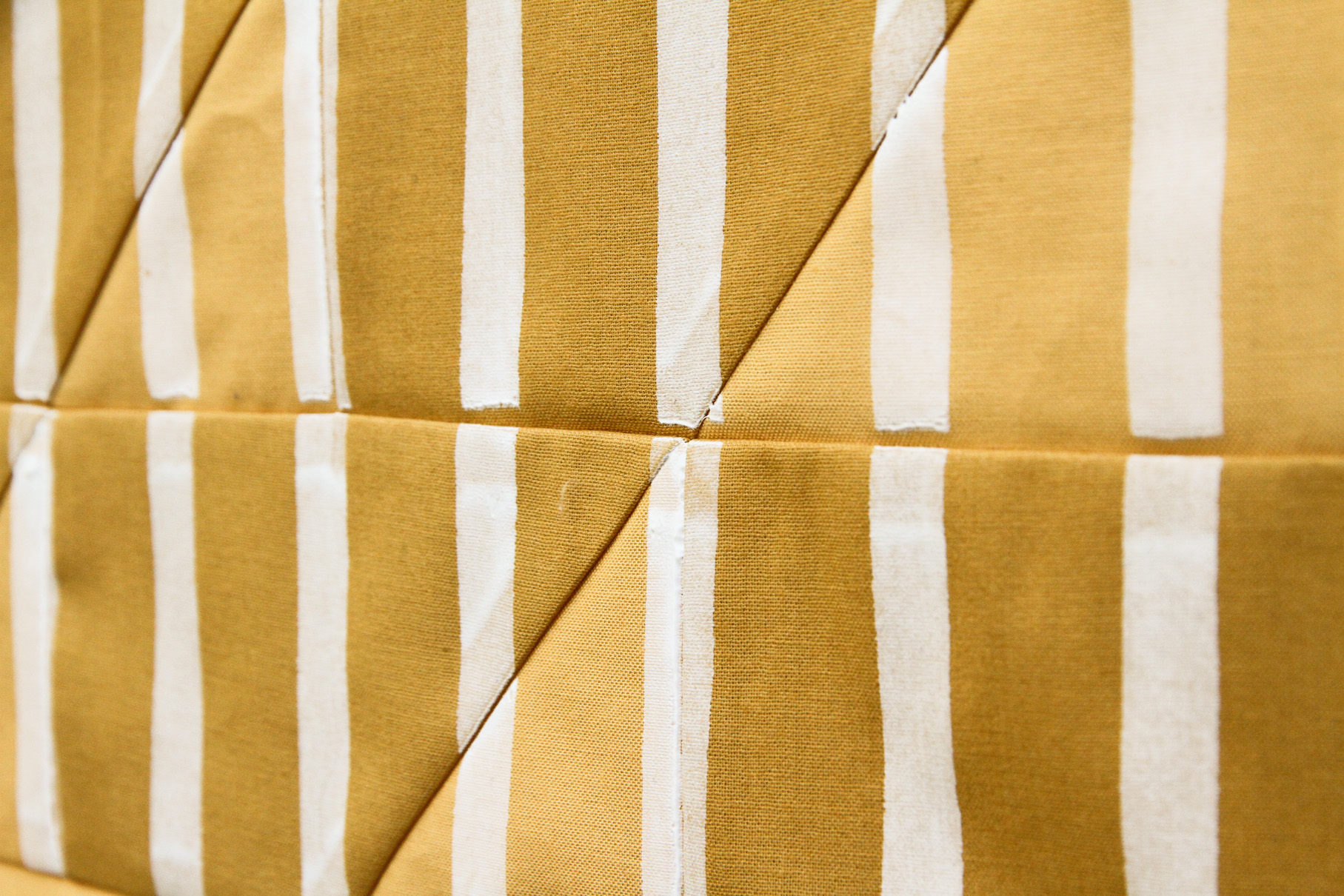 graphic white stripes screen-printed onto a mustard quilt | by Kelsey Boes