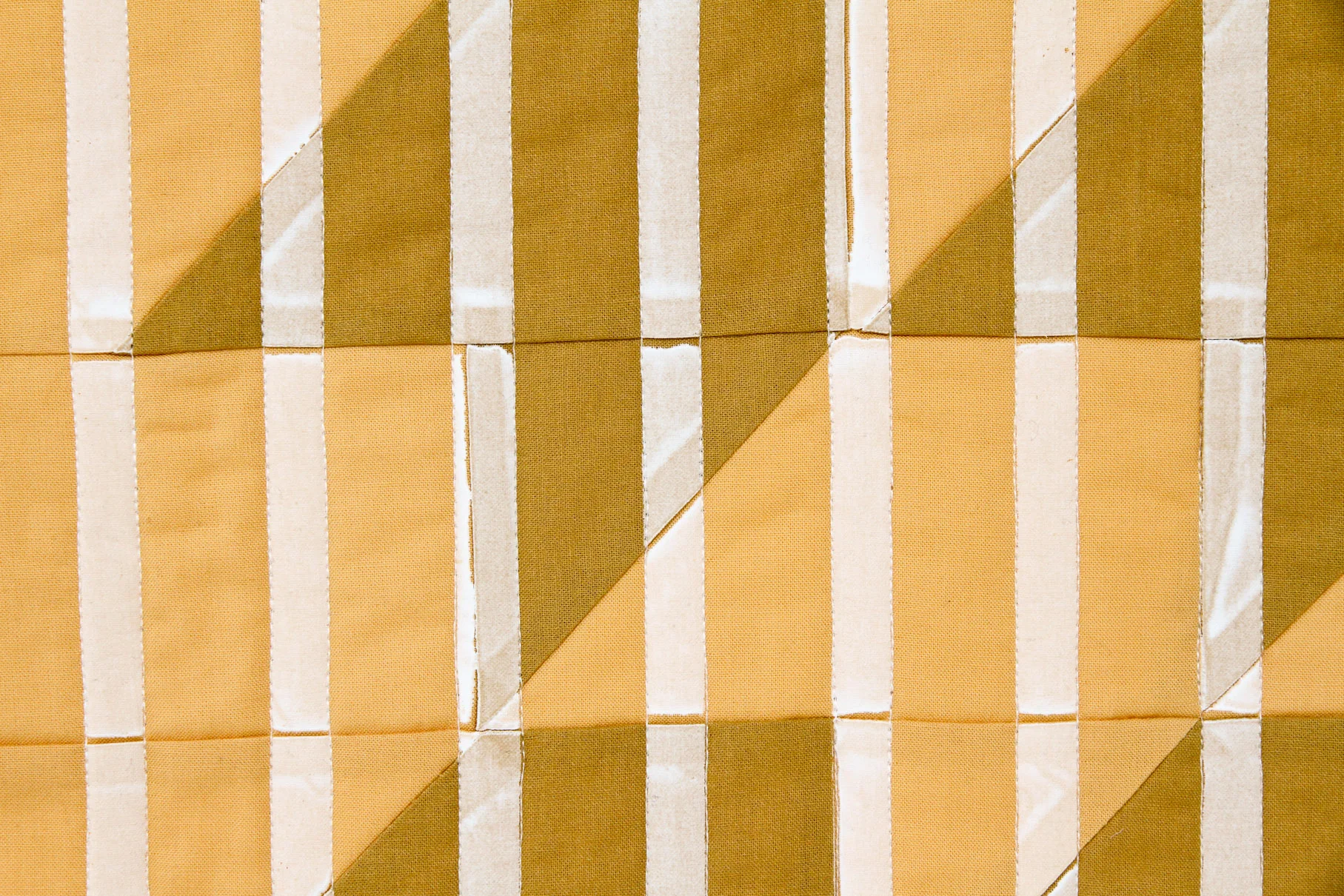 mustard Lenten Twelves One modern quilt printed with stripes, quilted and faced