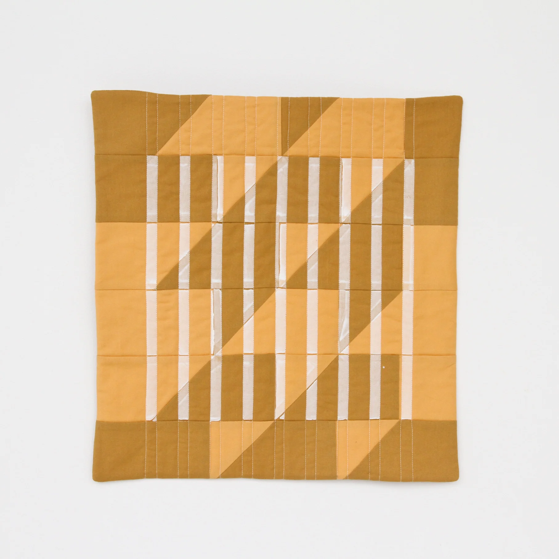 mustard Lenten Twelves One modern quilt printed with stripes, quilted and faced