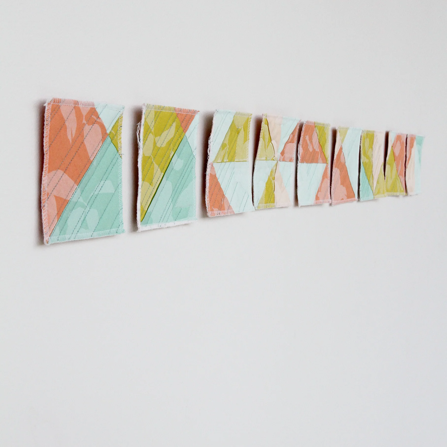 printed and deconstructed modern wall quilt rearranged from grid to line