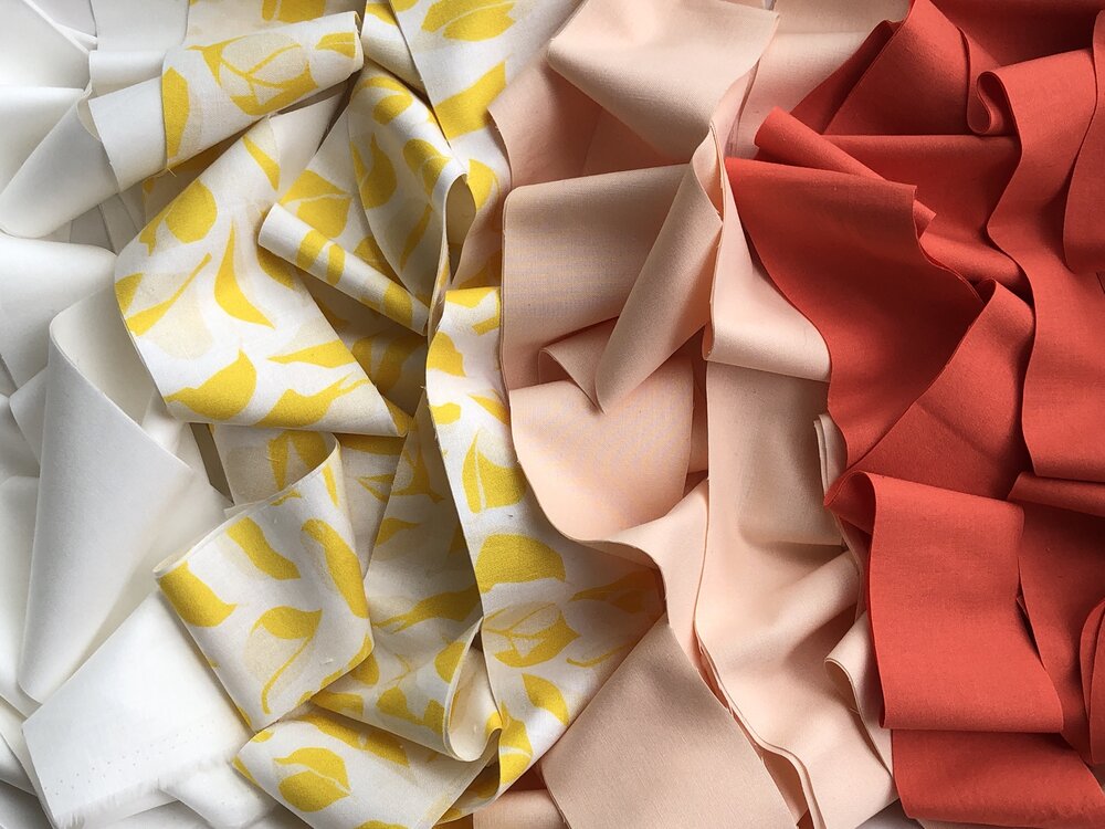 modern strip quilting in bright coral, peach, citron | Lovley and Enough