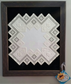 This is the piece selected for best of show for the art club's theme for this year, which was "Geometric Shape". This is a textile, Hardanger, a Norwegian cross stitch with cut outs by Priscilla Magaardan Andrews.