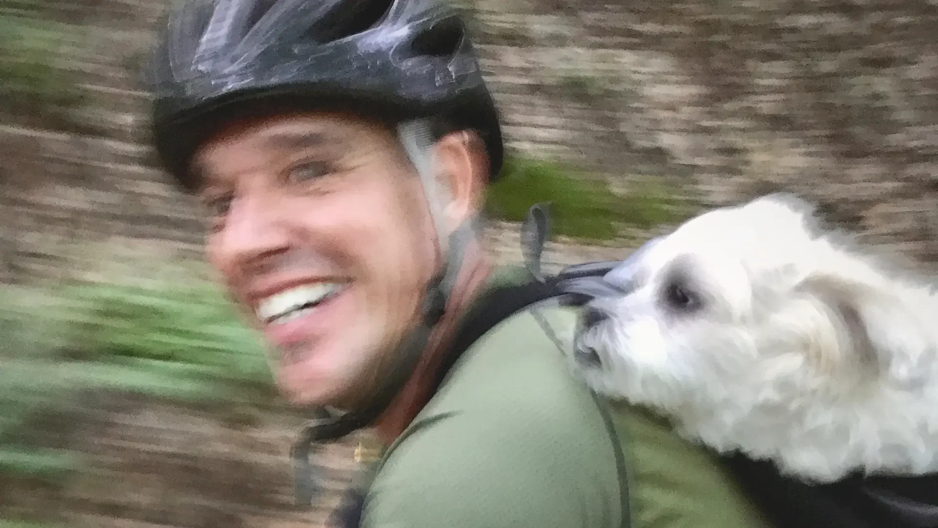 Corey Carthew professional voiceover artist riding bike with Scotty the dog