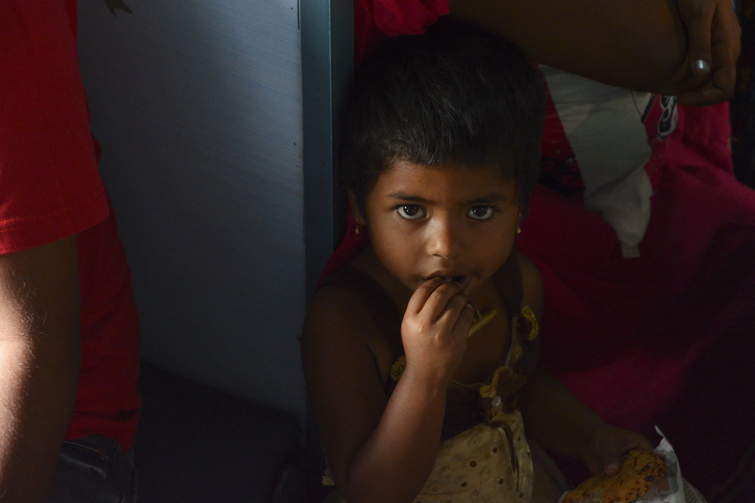 Girl eating vada on train.