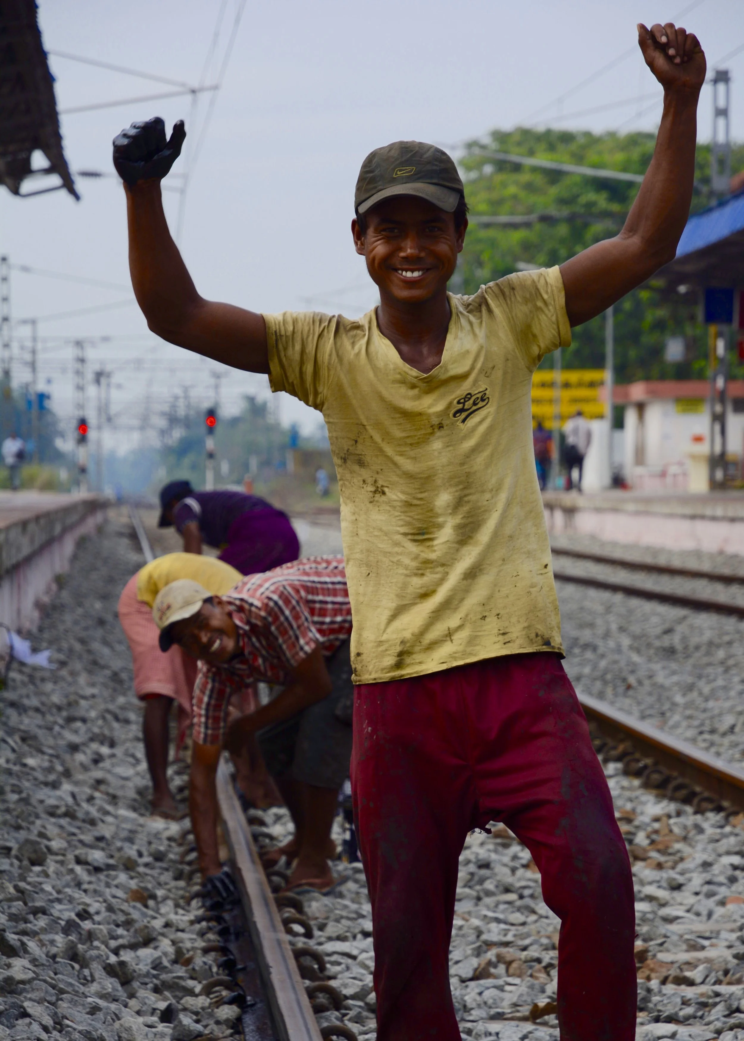 Young workers greasing tracks with bare hands.