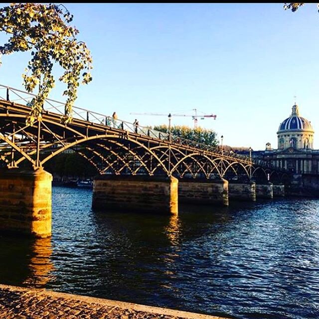 Like a beautiful iron balcony on a Haussmann building, the Pont des Arts crosses the Seine linking the rive gauche to the Louvre. On this day in 1984, Mayor of Paris, Jacques Chirac christened the newest version of the bridge. 
The first bridge or pa