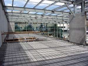Steel reinforcement to concrete mezzanine slab, structural steel including portal frames and precast panels.