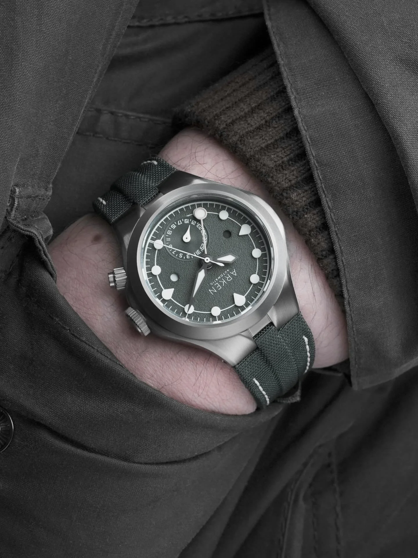 Less than 24 hours to first launch! 

By desaturating the iconic British racing green, this textured grey dial, in sunlight, presents dark sage tones synonymous with slate found in the quarries of Cumbria, UK. The addition of the sand dual-time hand 