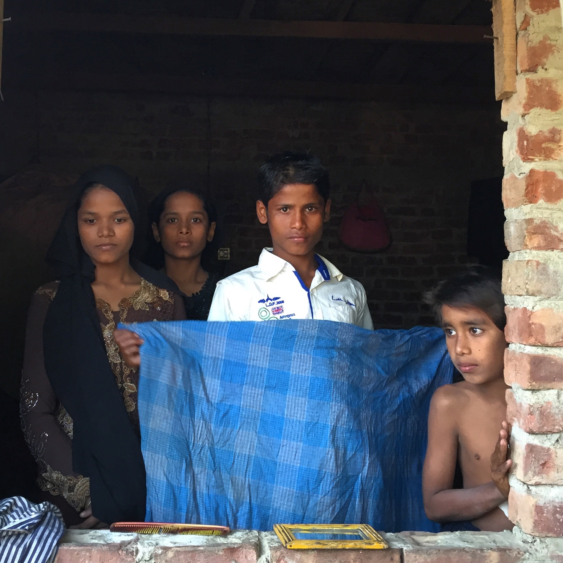 TEKNAF | A Rohingya boy with his siblings in Leda camp, a site for unregistered refugees. They are among the recent arrivals to the camp, fleeing a brutal counterinsurgency campaign in Myanmar. January 19, 2017. 