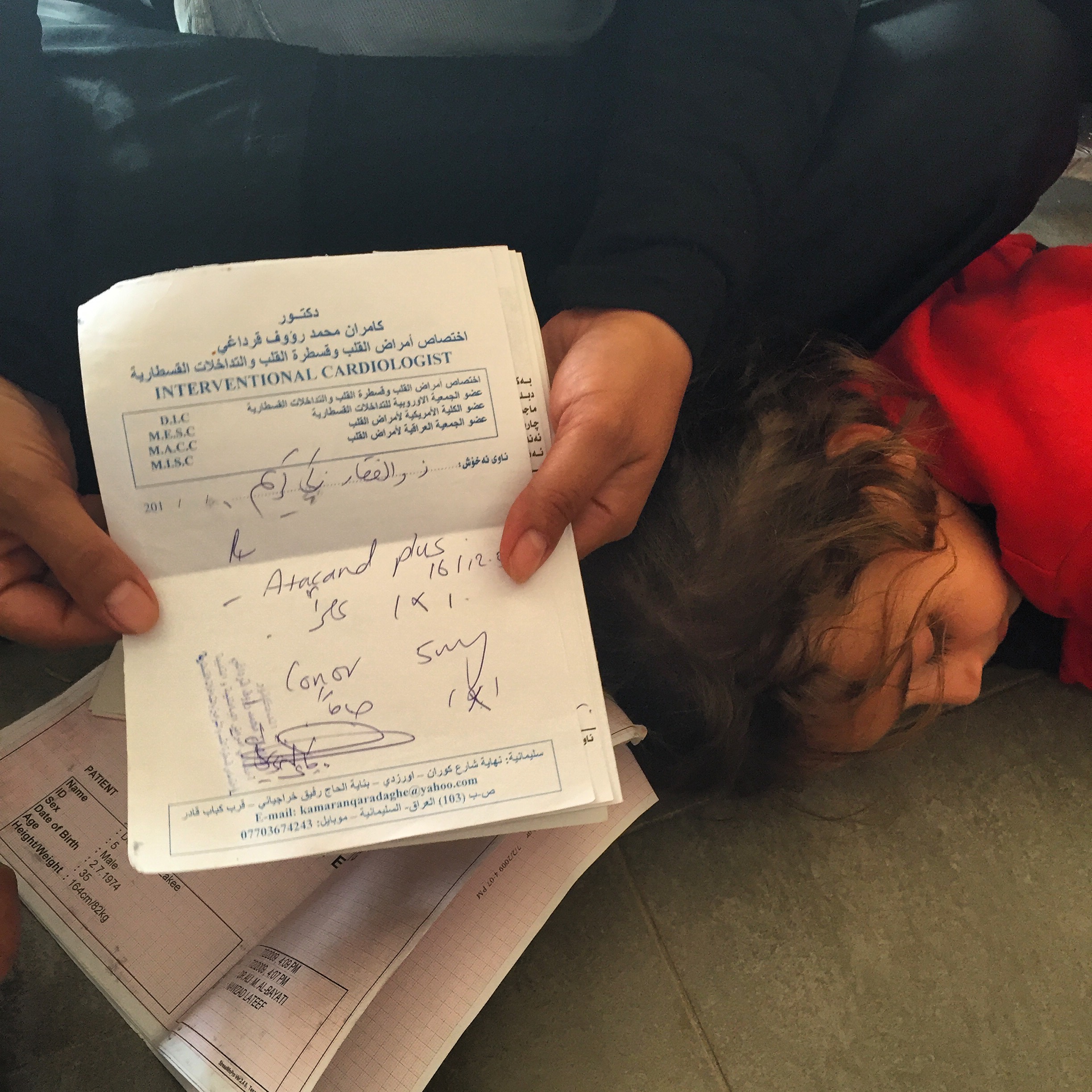 DEBAGA CAMP | An internally displaced woman from Hawija shows me documents proving her missing husband has a serious cardiac condition. He was taken by the Peshmurga when they crossed the frontline just five days before, she said. "They suspect he is ISIS, but I know him. He is not." Her teenage son is also in a holding facility inside the camp for additional security screening. October 28, 2016. 